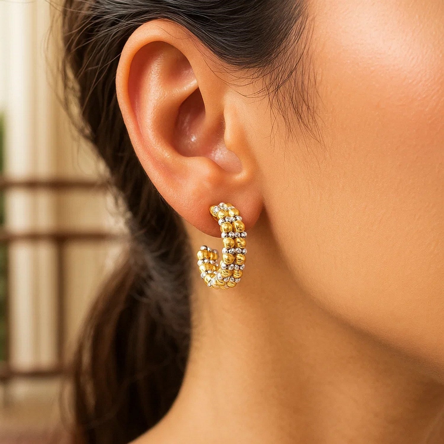 14K two-tone gold hoop earrings adorned with elegant pallina beads, showcasing modern luxury design.
