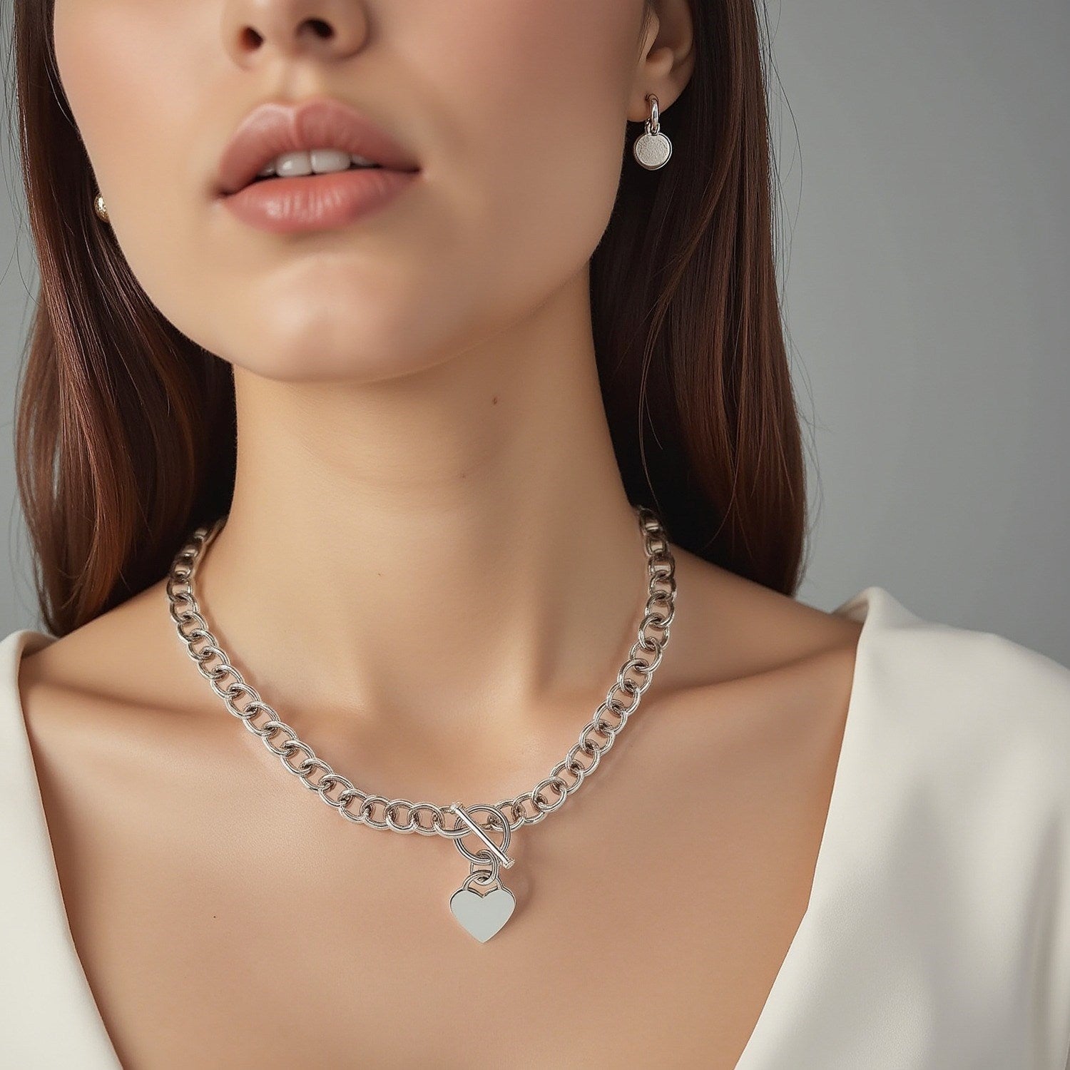 Sterling silver rolo chain necklace featuring a heart toggle charm and elegant rhodium plating, perfect for modern luxury.