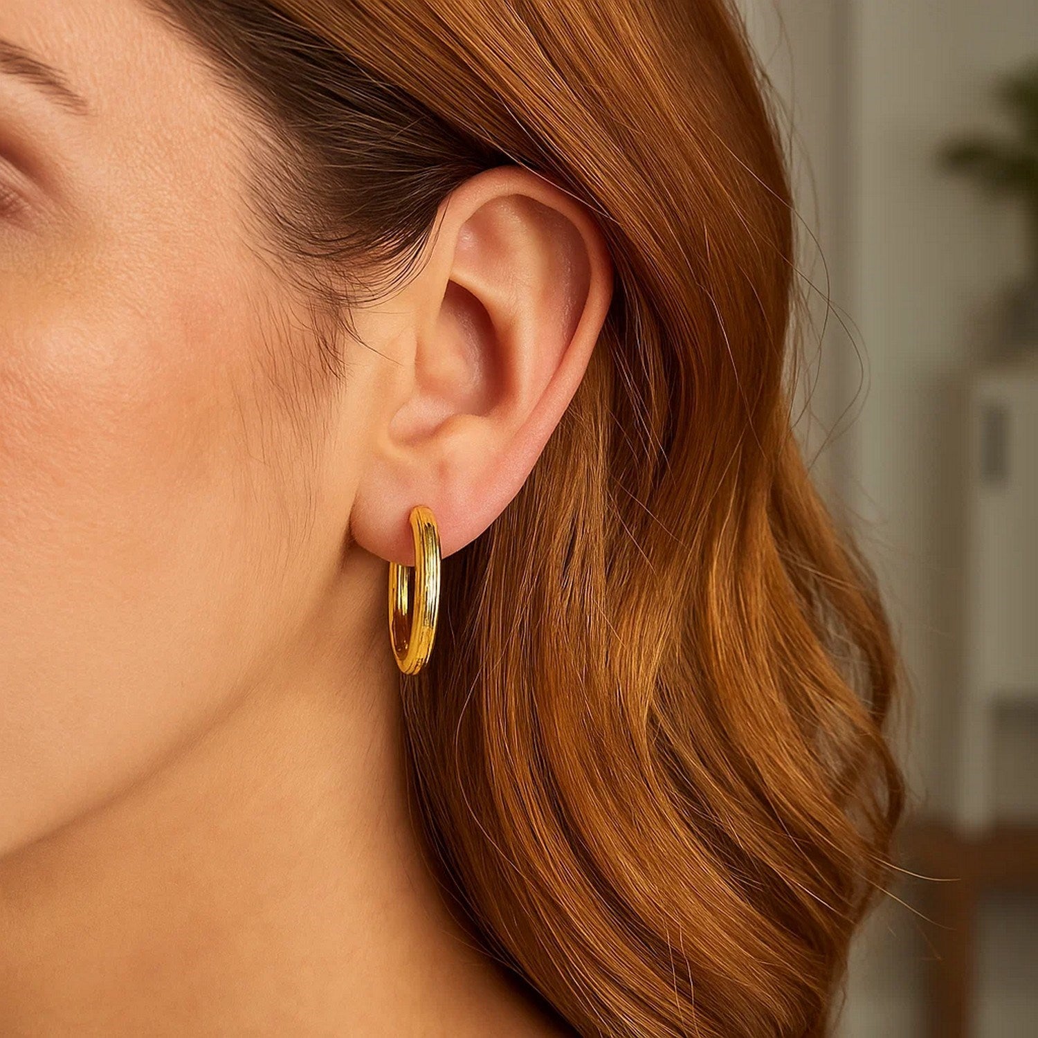14k yellow gold modern engraved round hoop earrings showcasing elegant craftsmanship and timeless design.