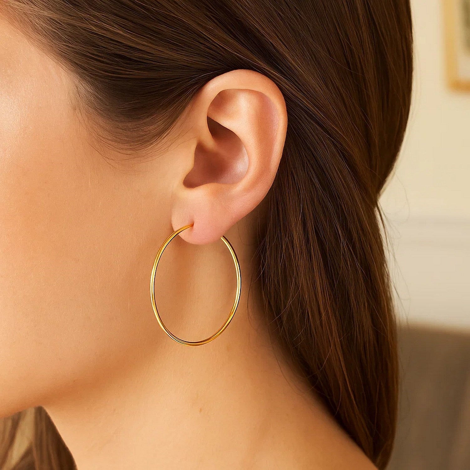 Polished 10k yellow gold hoop earrings with a modern design, showcasing exquisite craftsmanship and elegance.