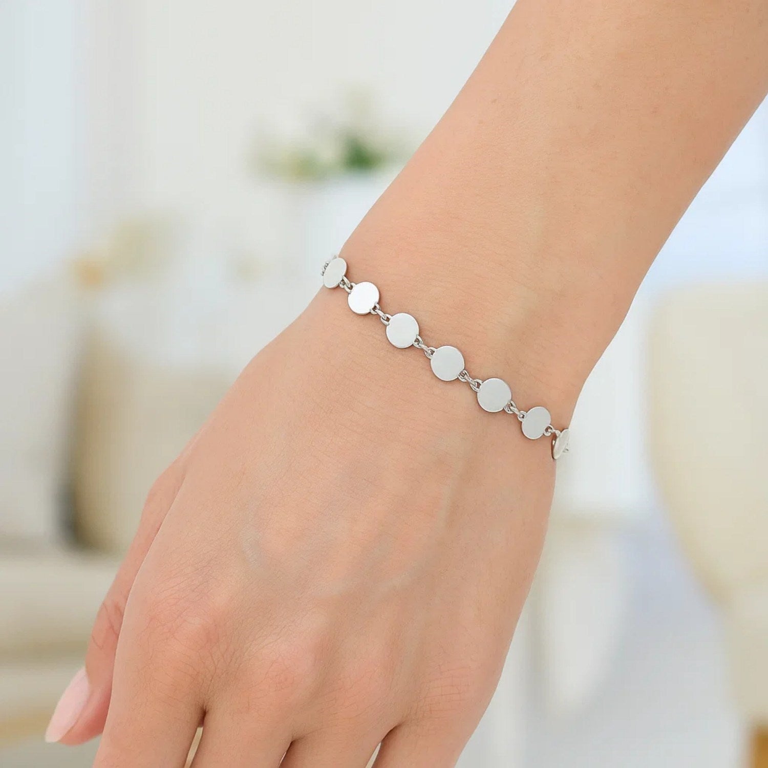14k white gold bracelet featuring polished circles in a modern chain design, perfect for elegant layering.