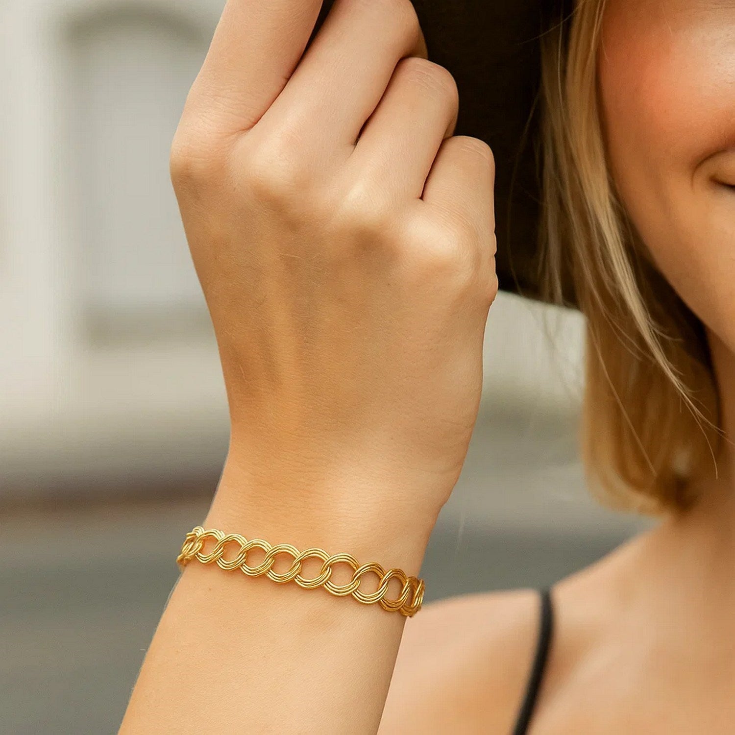 14k yellow gold modern triple link charm bracelet showcasing elegant design and luxurious craftsmanship.
