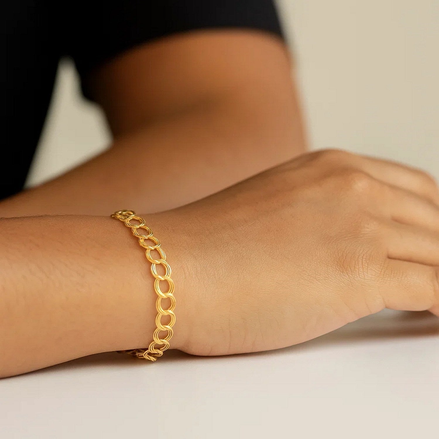 14k yellow gold triple link charm bracelet with modern design and elegant shine, perfect for luxury jewelry lovers.