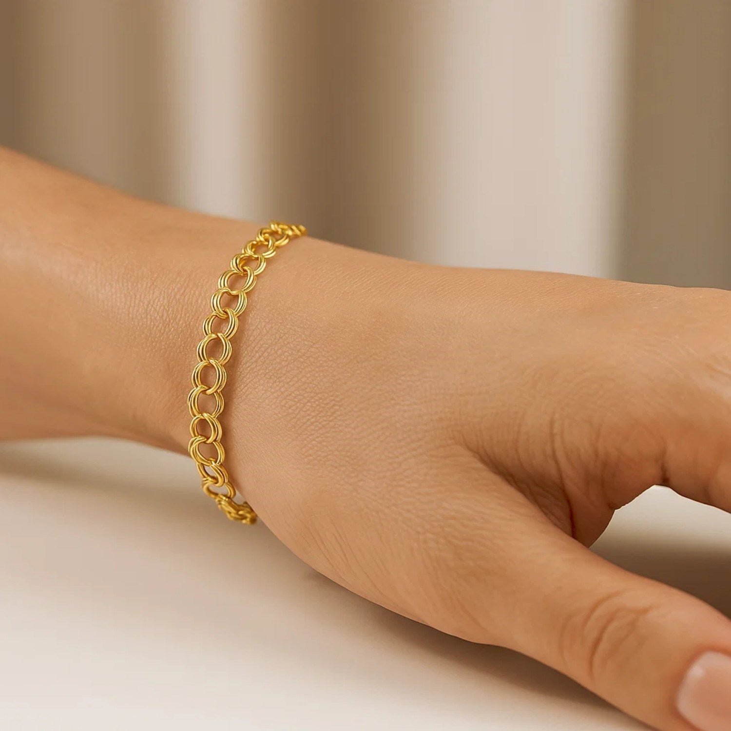14k yellow gold charm bracelet featuring classic stud design, elegantly crafted for timeless luxury.