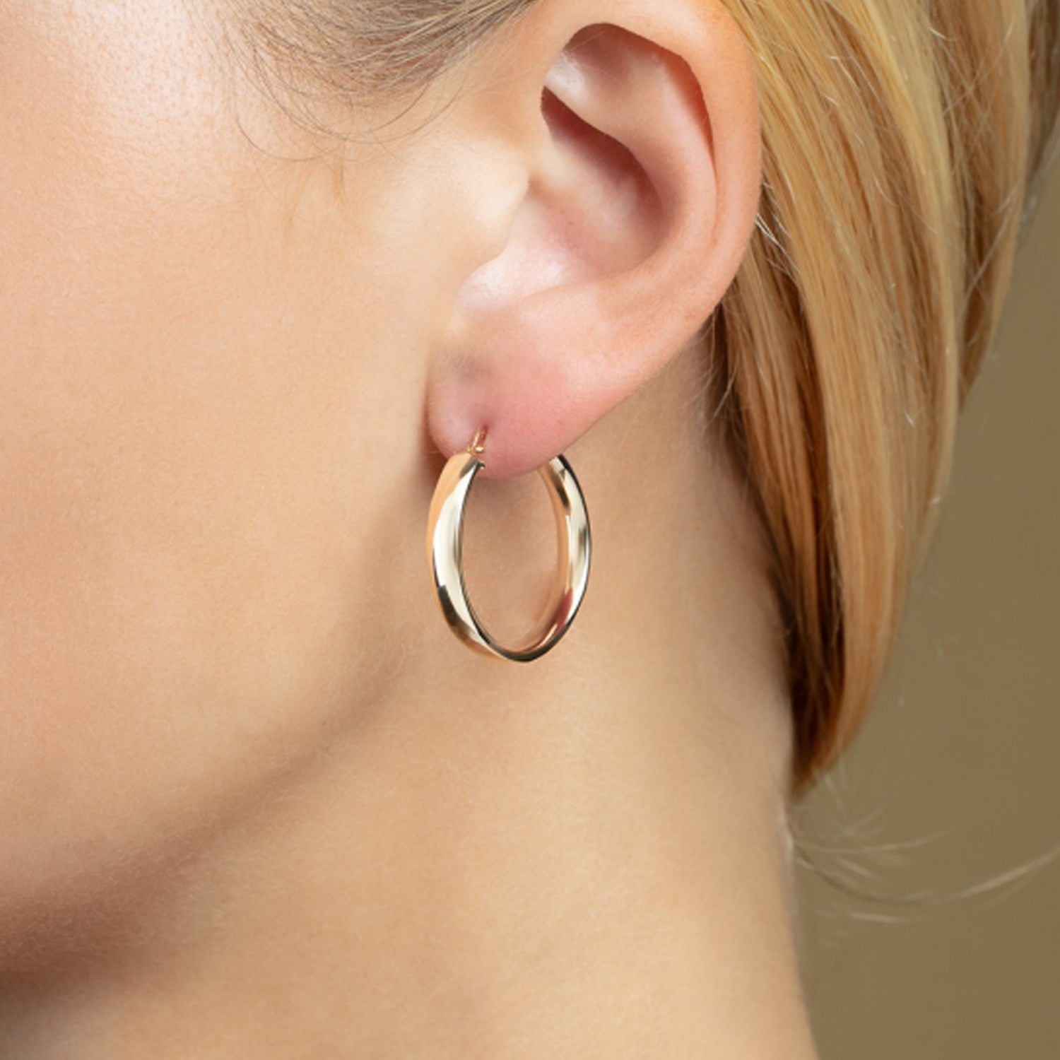 14k yellow gold polished hoop earrings with a sleek modern design, perfect for elegant everyday wear.