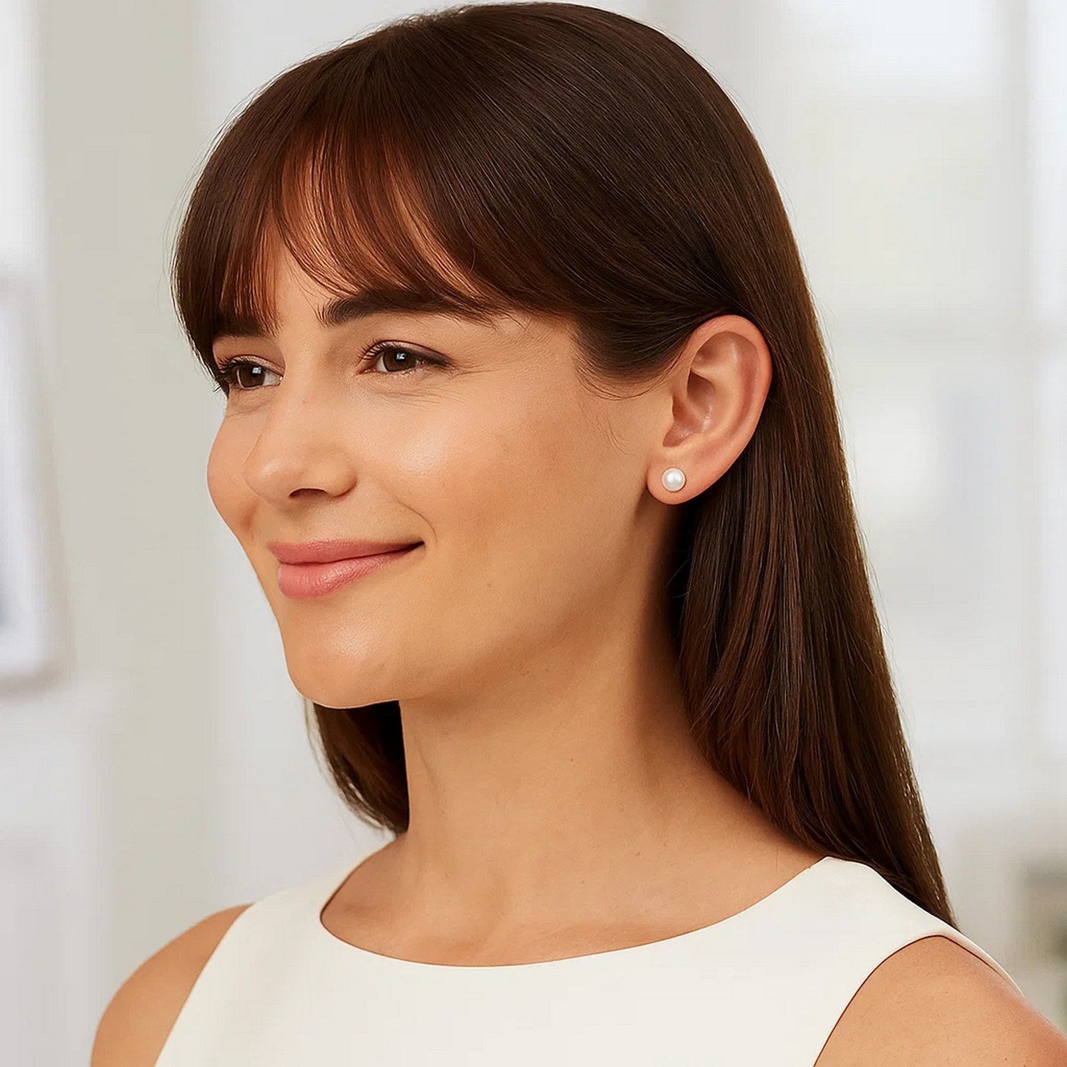 14k yellow gold stud earrings featuring 8mm round freshwater cultured pearls in a modern design.