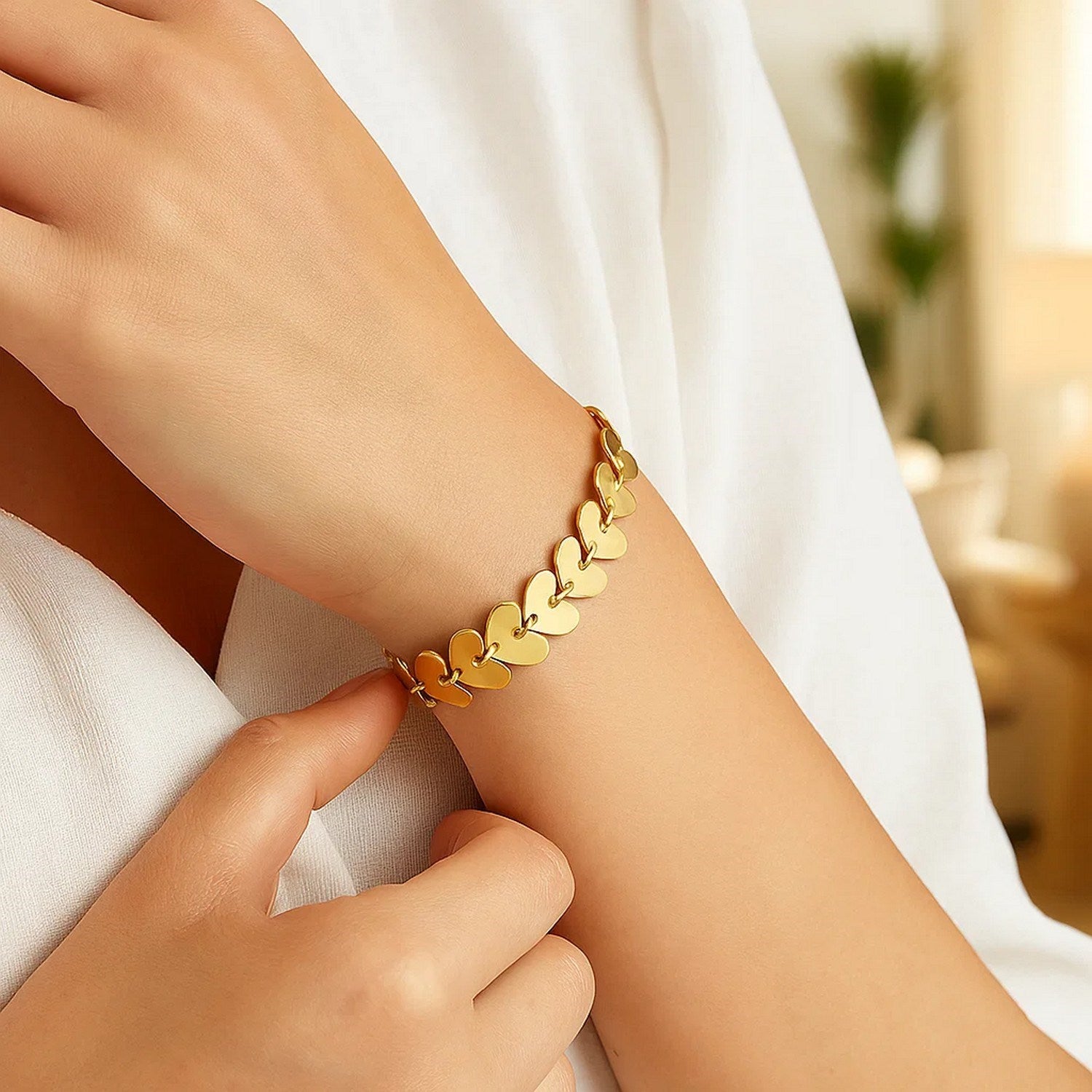 14k yellow gold heart link bracelet with modern chain design, showcasing elegance and luxury craftsmanship.