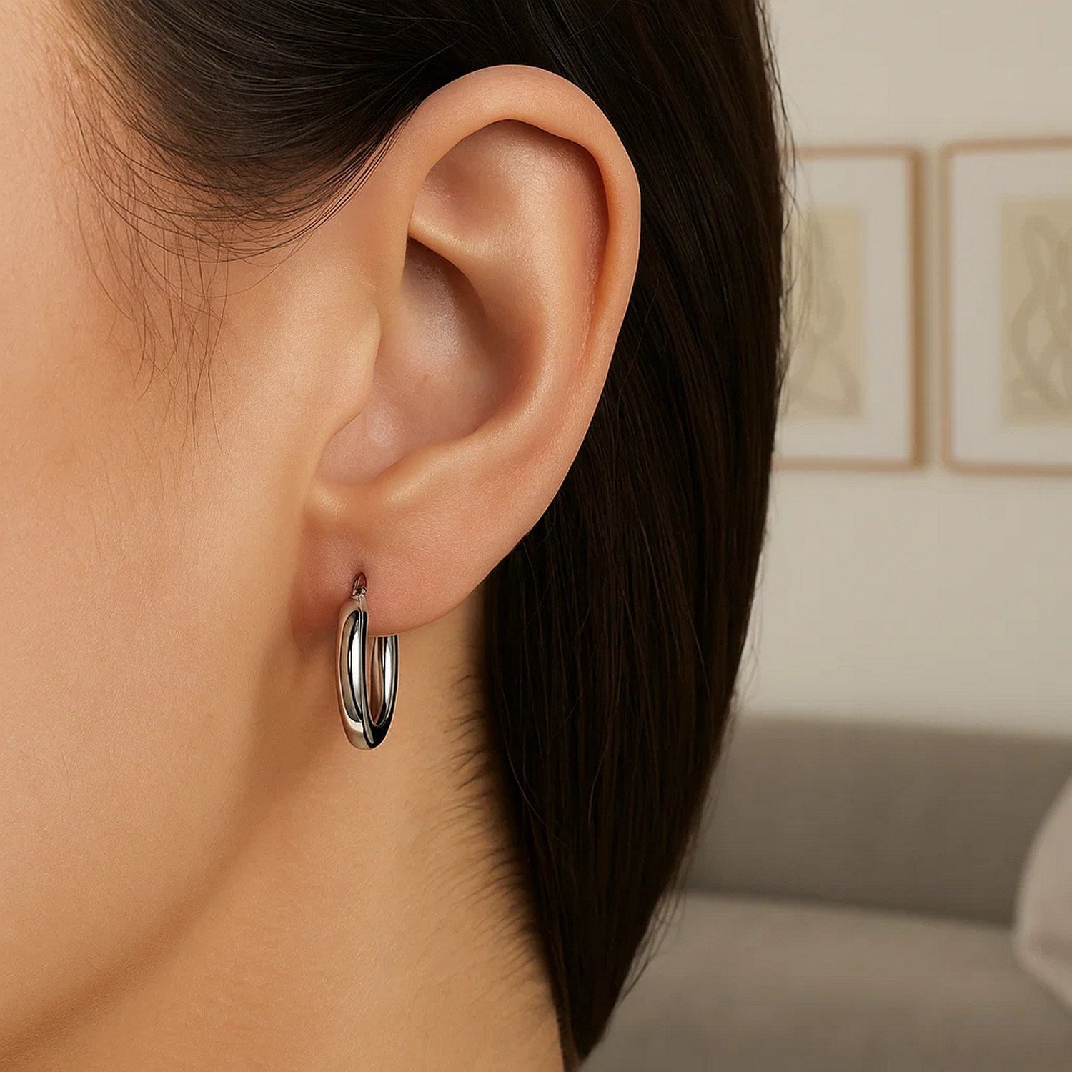 Polished 14k white gold hoop earrings with a modern design, showcasing elegant craftsmanship and timeless style.