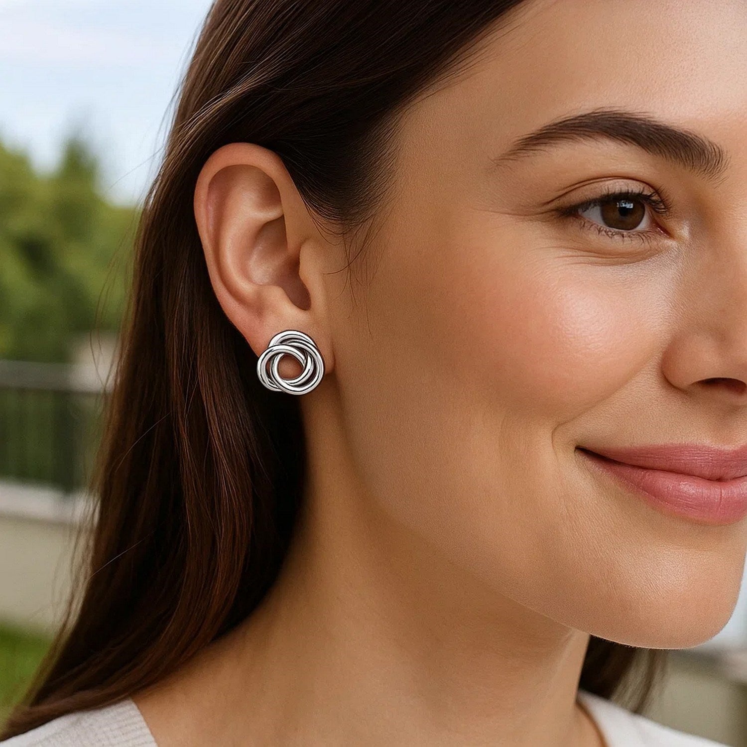 Polished sterling silver open love knot earrings featuring a modern design for an elegant touch.