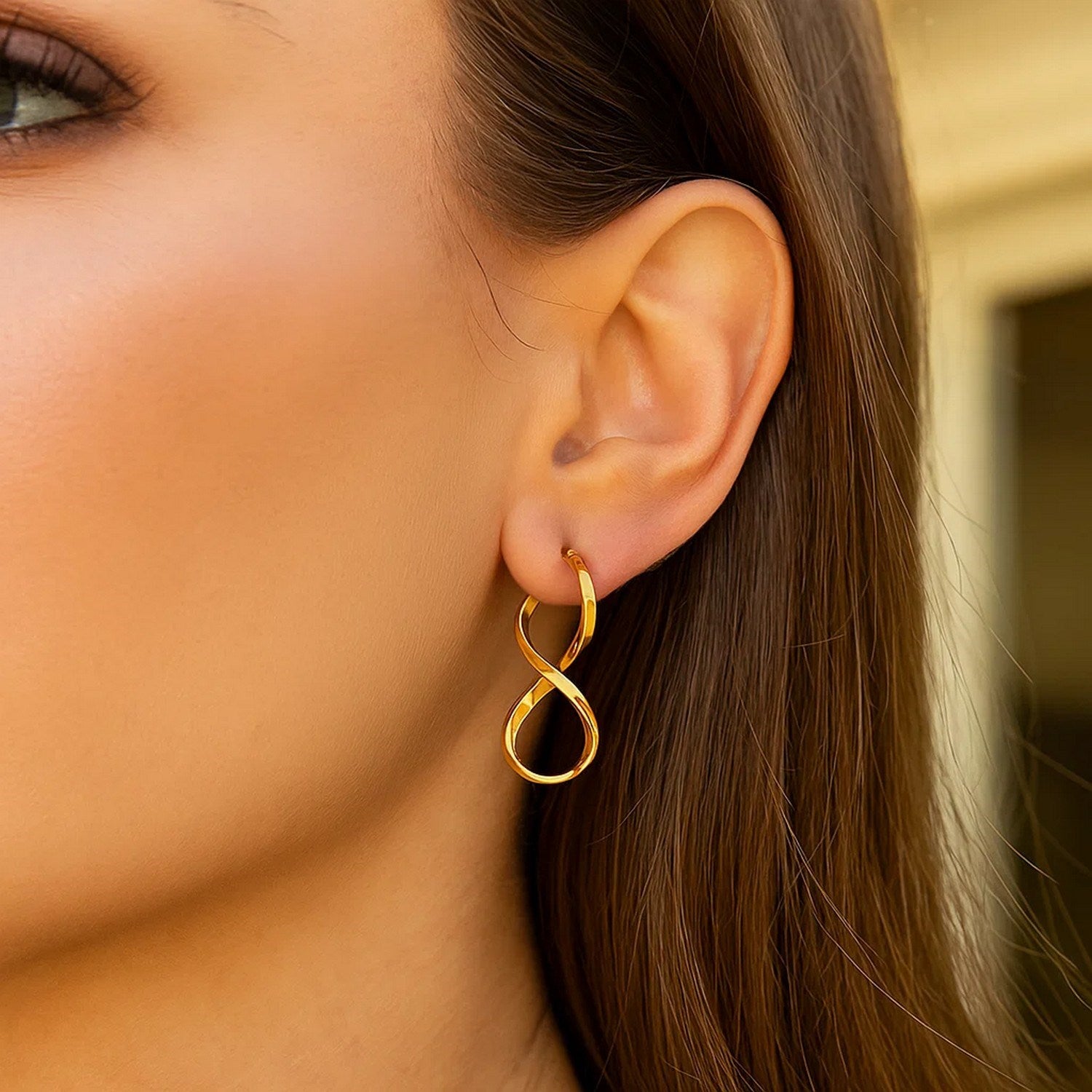 Elegant 14k yellow gold polished drop earrings showcasing a timeless infinity design for a luxurious look.