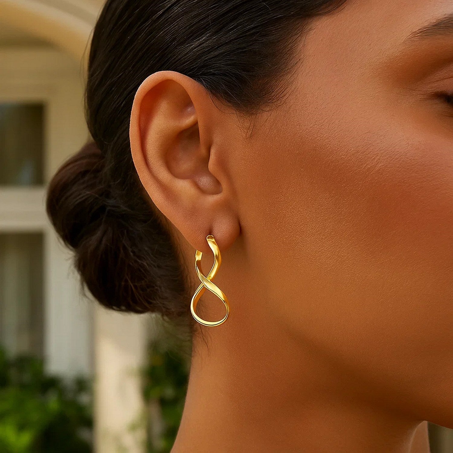 Elegant 14k yellow gold polished infinity drop earrings showcasing a timeless design and luxurious finish.