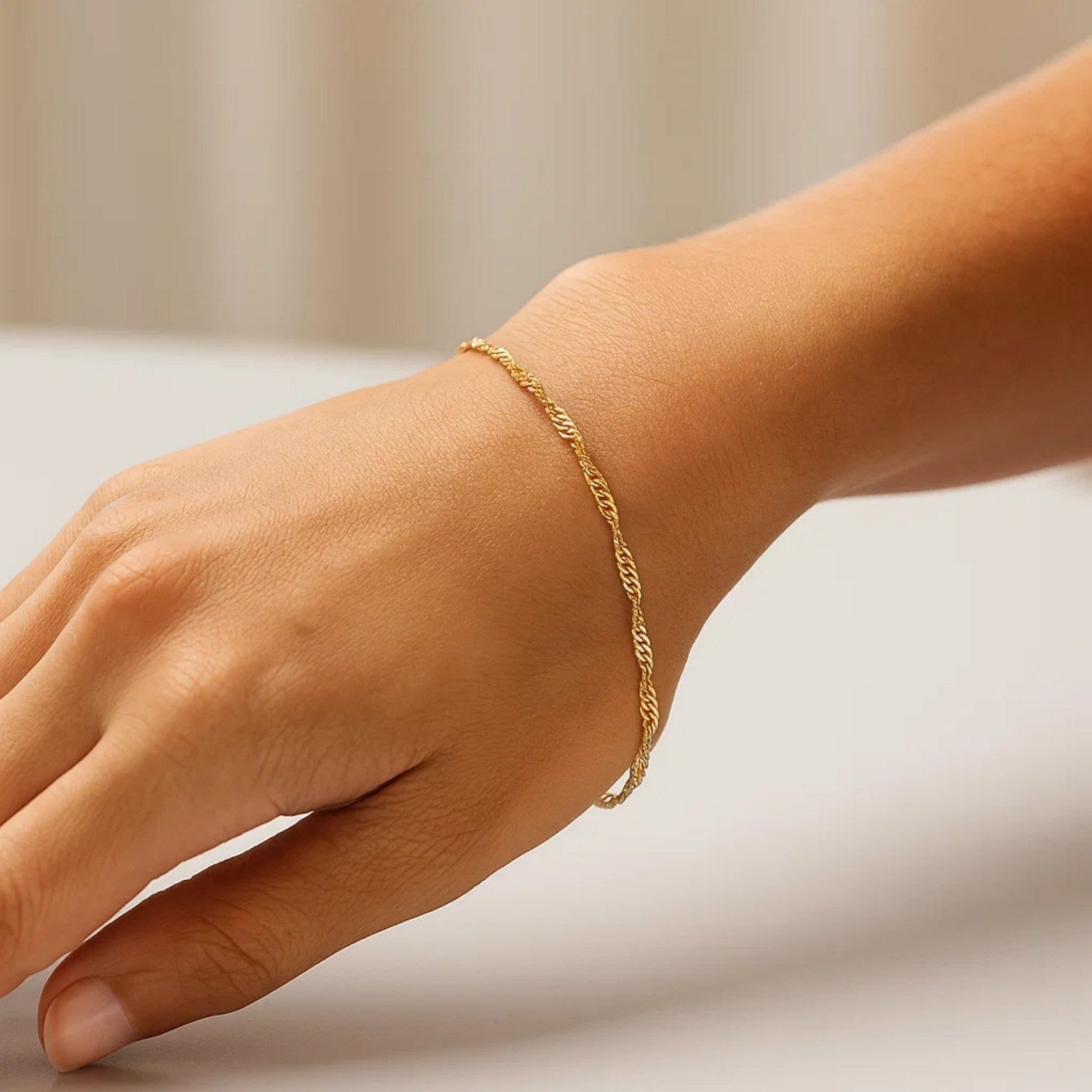 14k yellow gold Singapore bracelet featuring a classic chain design, perfect for elegant layering or solo wear.