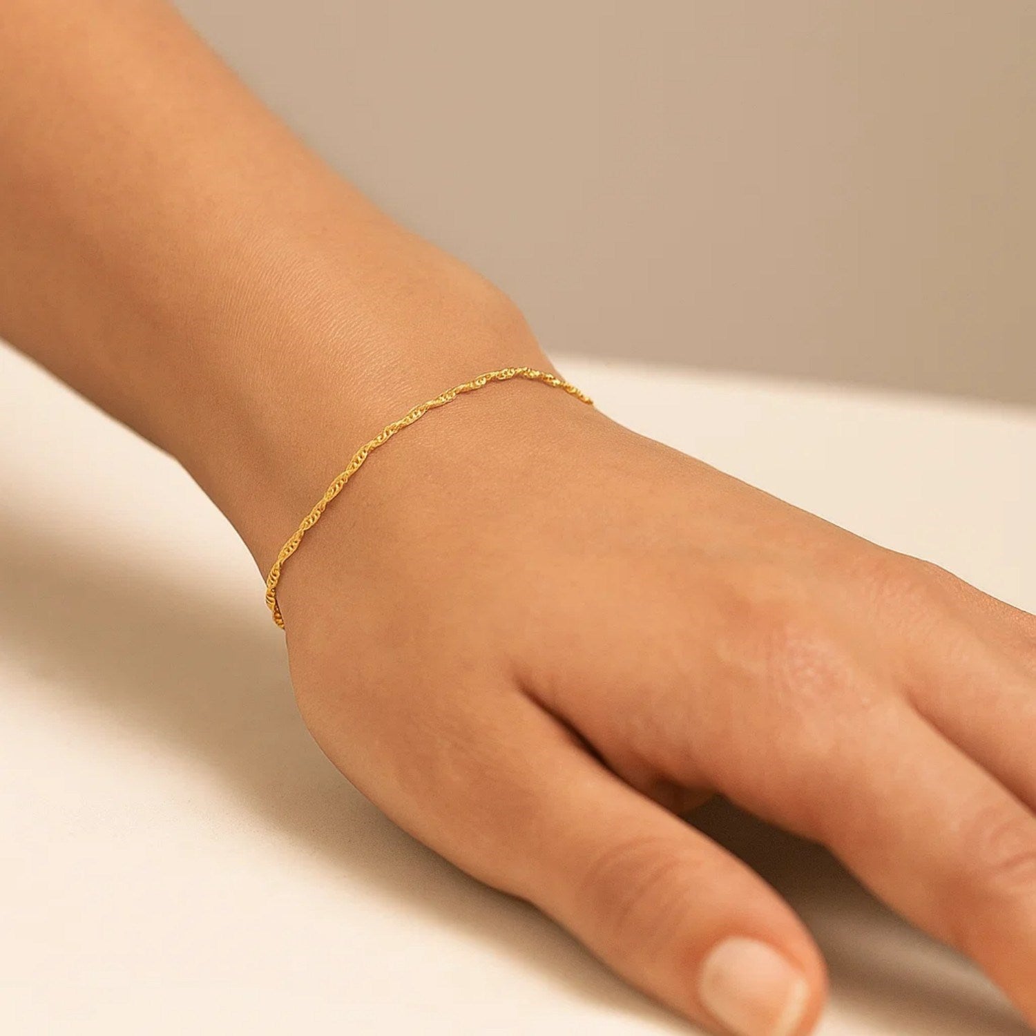 14k yellow gold Singapore bracelet with a classic chain design, showcasing elegance and timeless luxury.