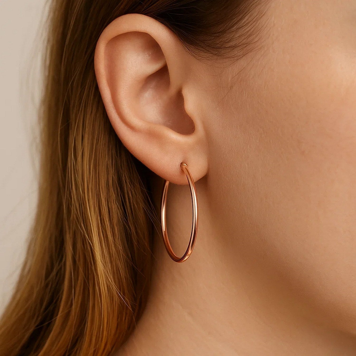 14k rose gold polished hoop earrings with a sleek modern design, perfect for elegant everyday wear.