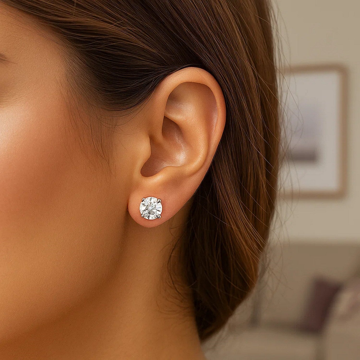 Sterling silver polished stud earrings featuring prong-set white hue cubic zirconia for an elegant touch.