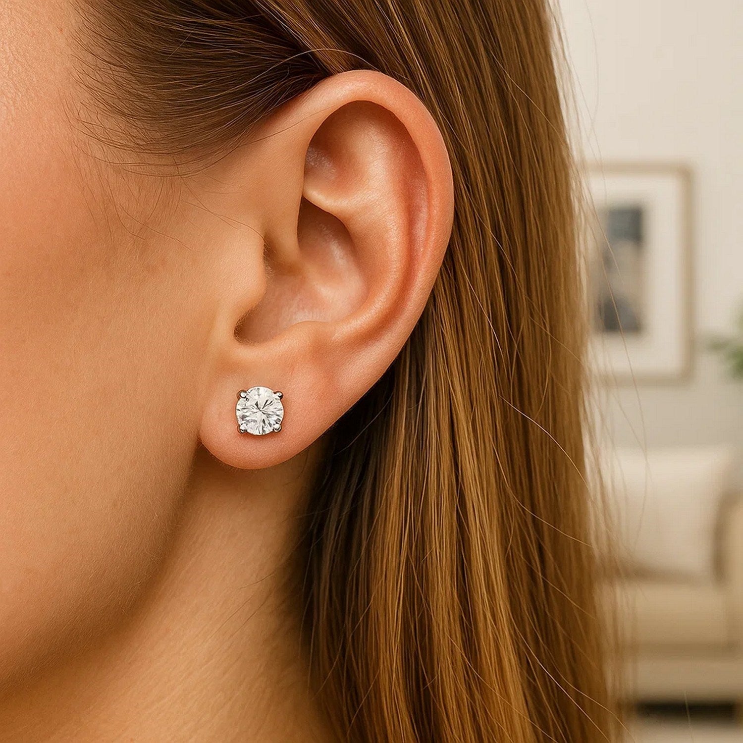 Sterling silver polished stud earrings featuring faceted white hue cubic zirconia in elegant prong setting.