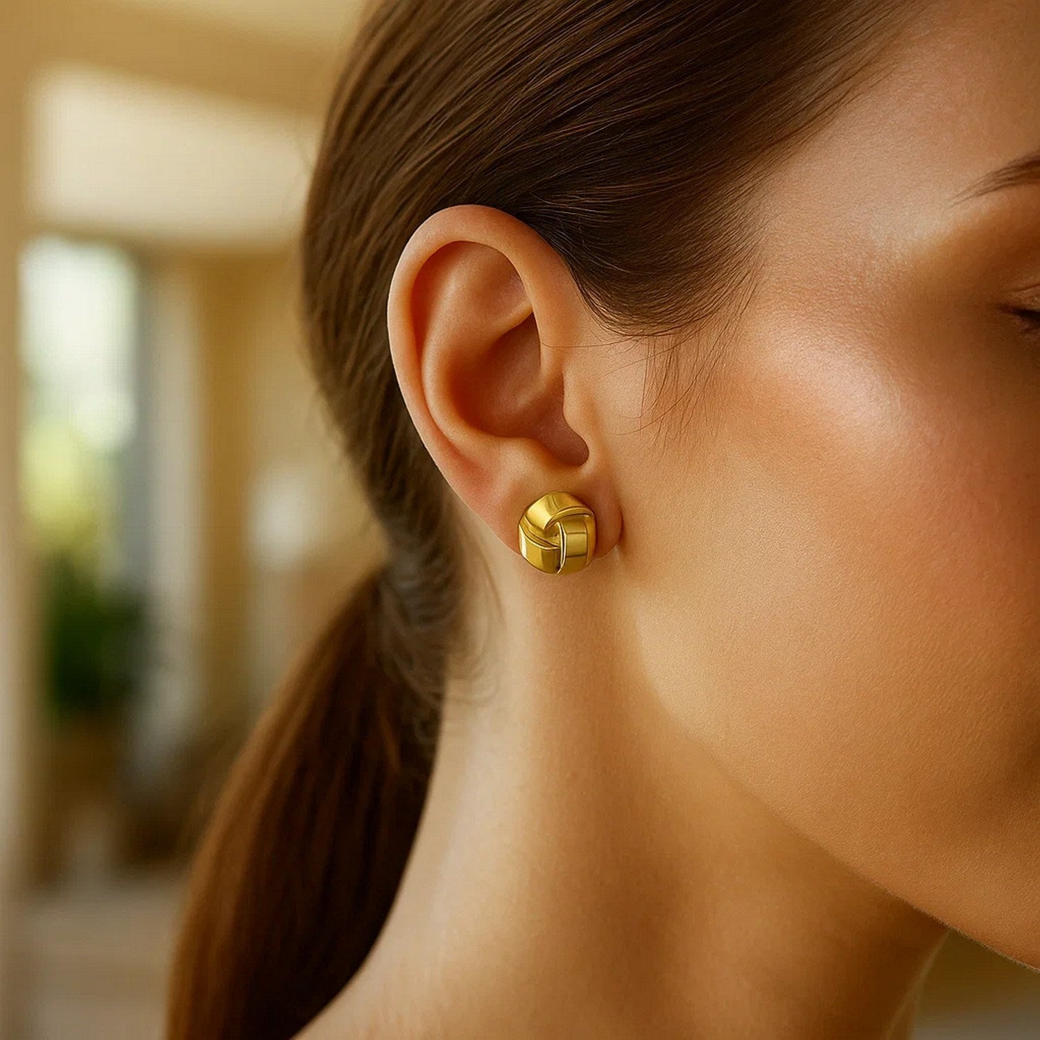 14k yellow gold modern fancy knot stud earrings showcasing elegant design and timeless luxury.