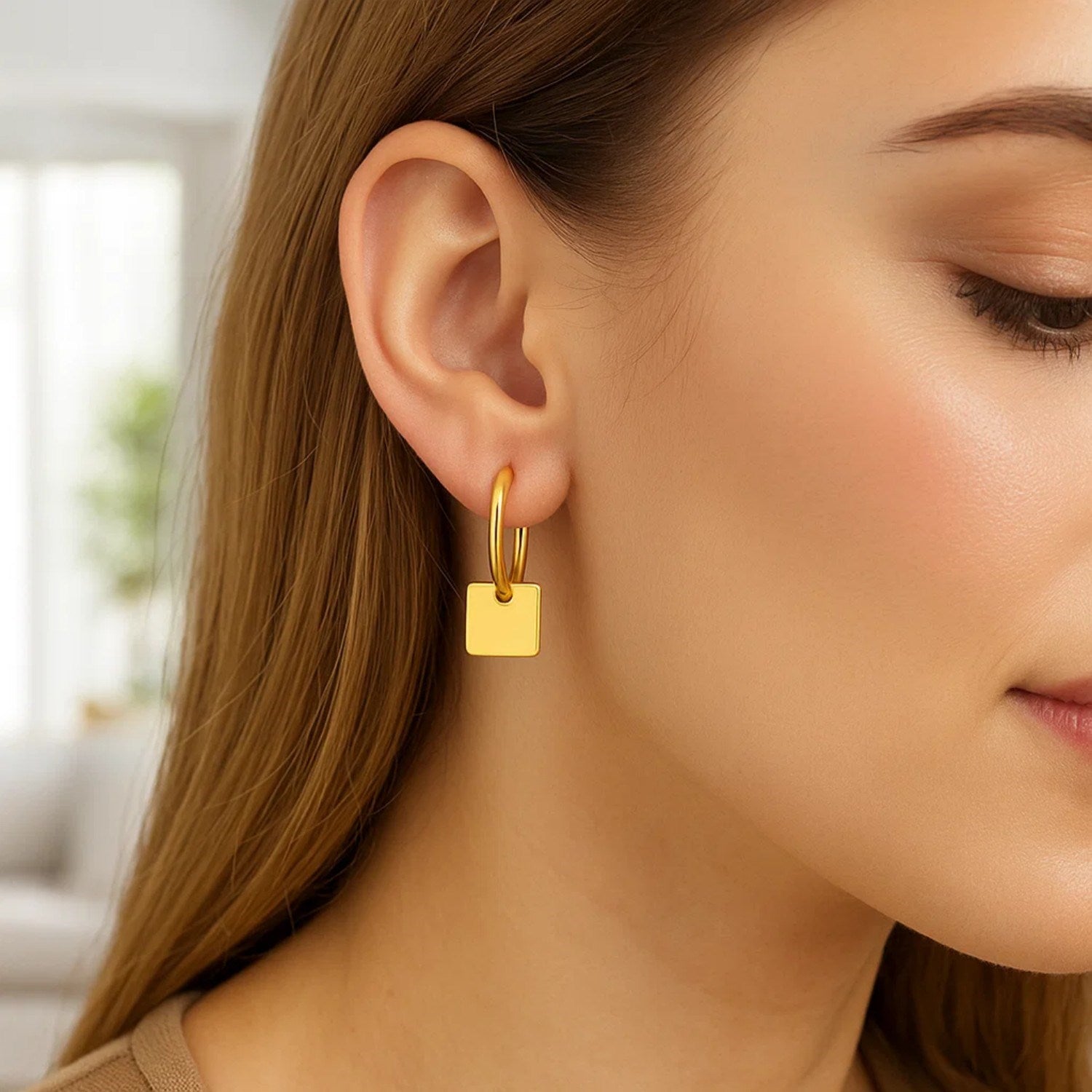 14k yellow gold polished huggie hoop earrings featuring elegant square drop accents for a modern touch.