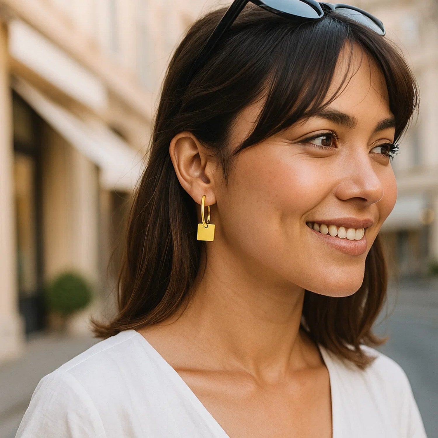 14k yellow gold polished huggie hoop earrings featuring elegant square drop accents in a modern design.