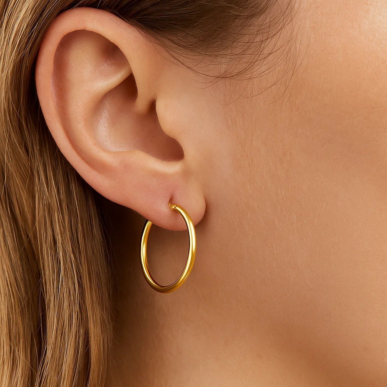 14k yellow gold polished hoop earrings with a sleek modern design, perfect for any elegant occasion.