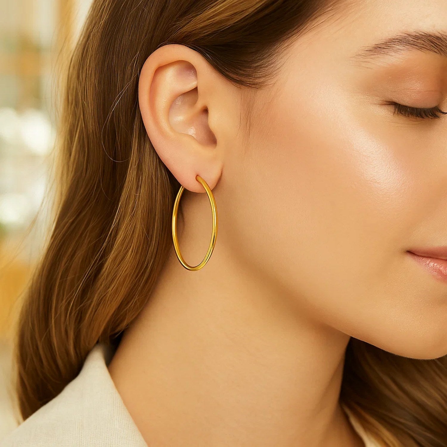 Elegant 14k yellow gold polished hoop earrings, 30mm, showcasing a refined and timeless design for luxury wear.