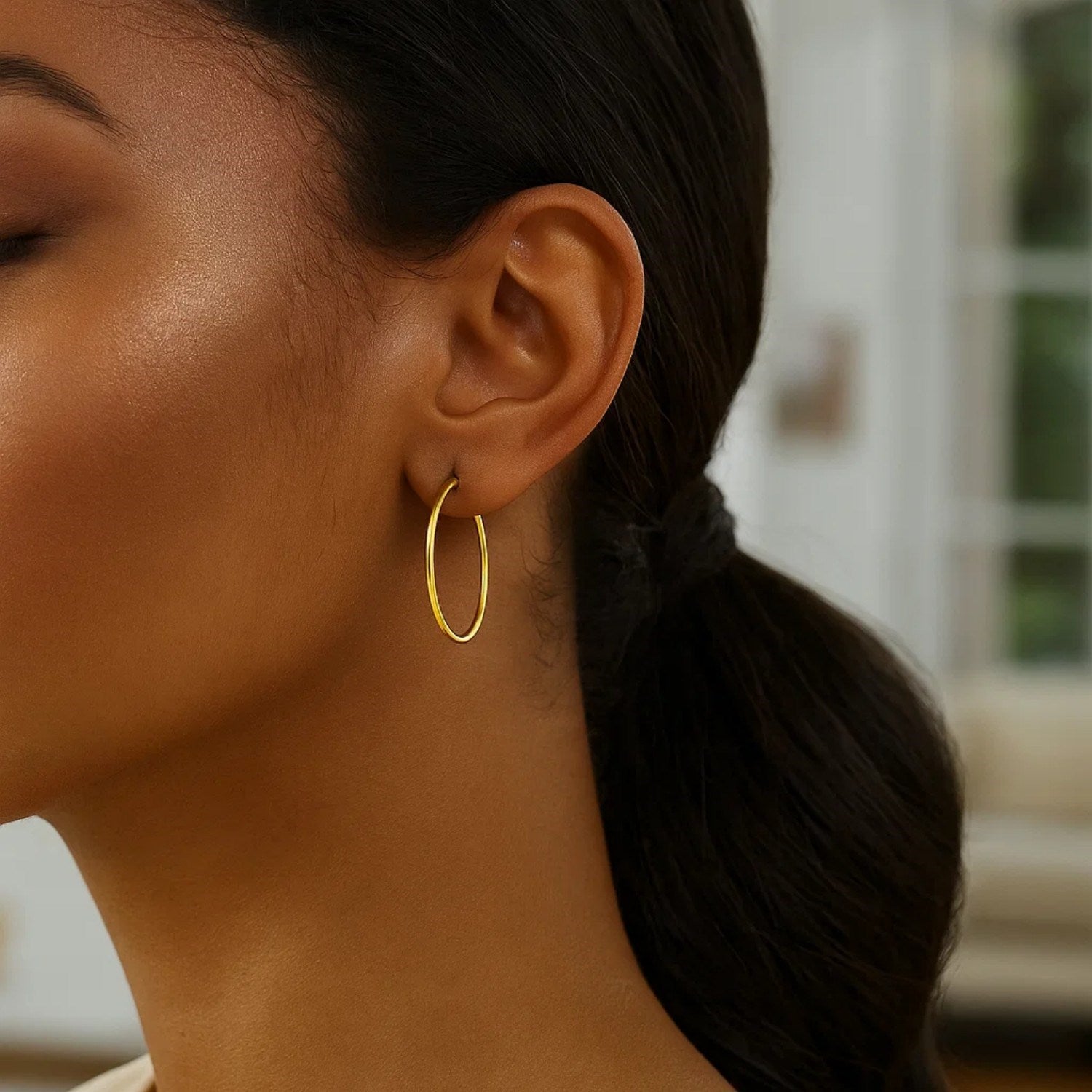 Elegant 14k yellow gold polished hoop earrings, 30mm, showcasing a timeless design for refined style.