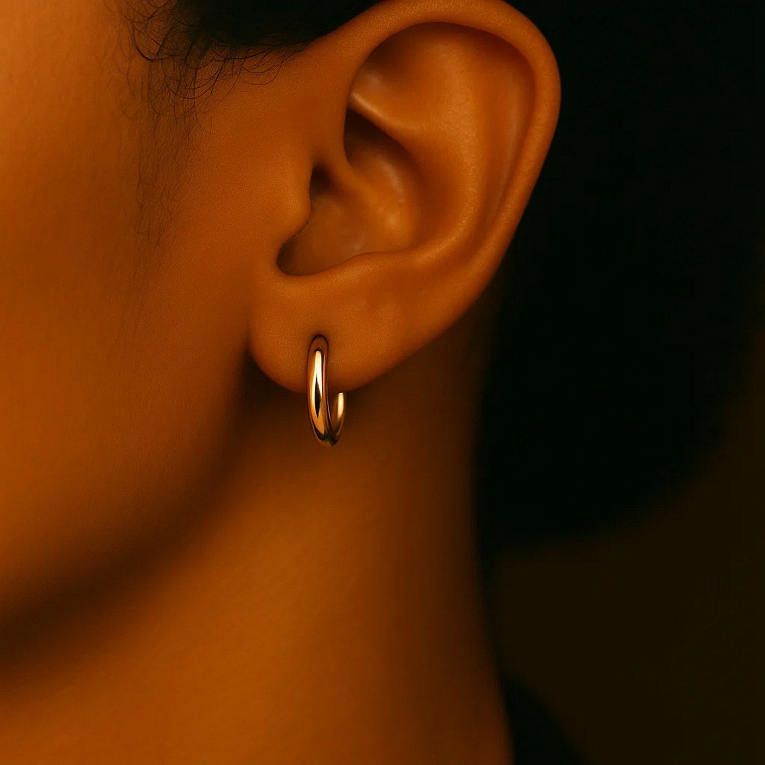 14k yellow gold polished hoop earrings, modern design, 15mm diameter, perfect for elegant everyday wear.