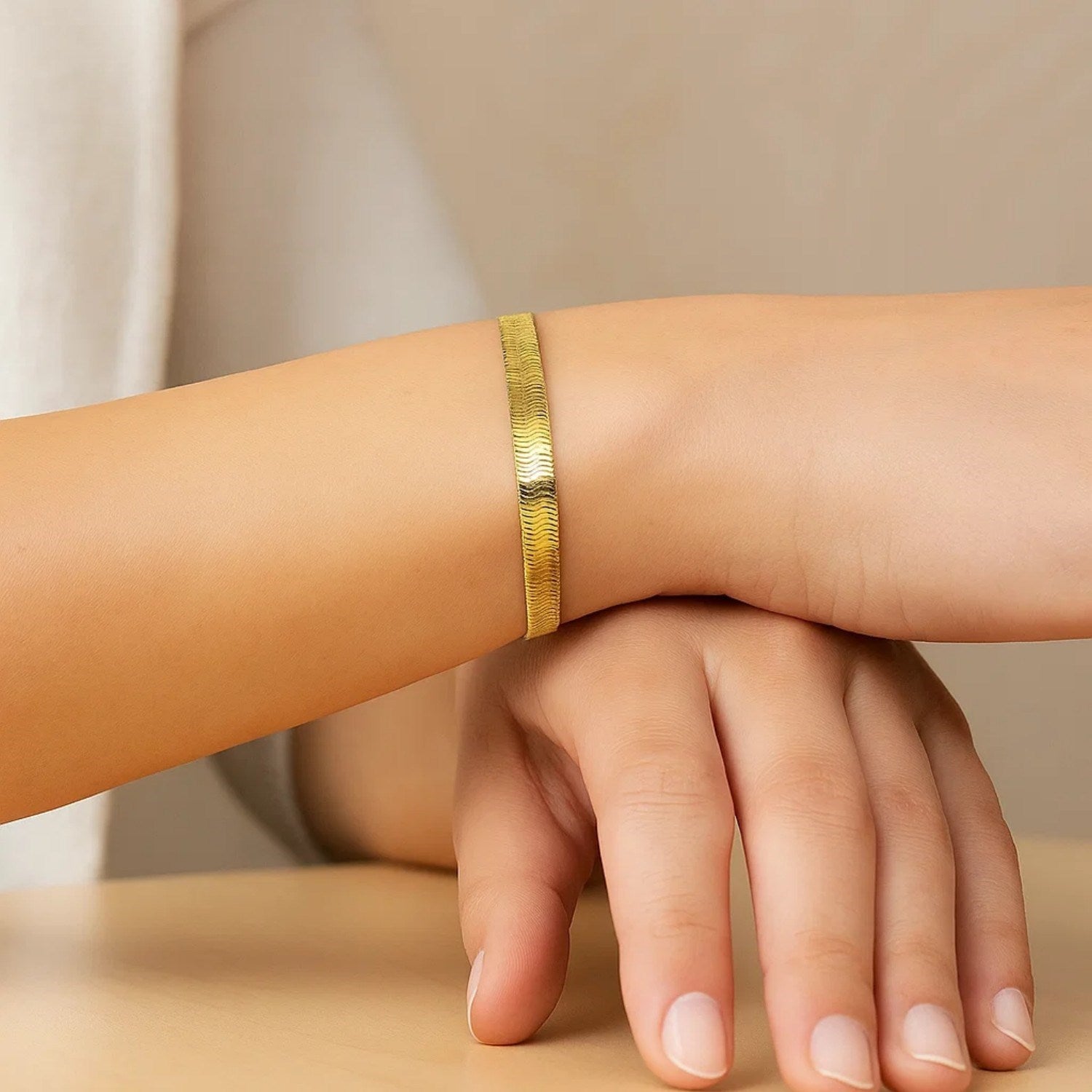 14k yellow gold modern herringbone bracelet with a sleek, flexible design, showcasing elegance and luxury.