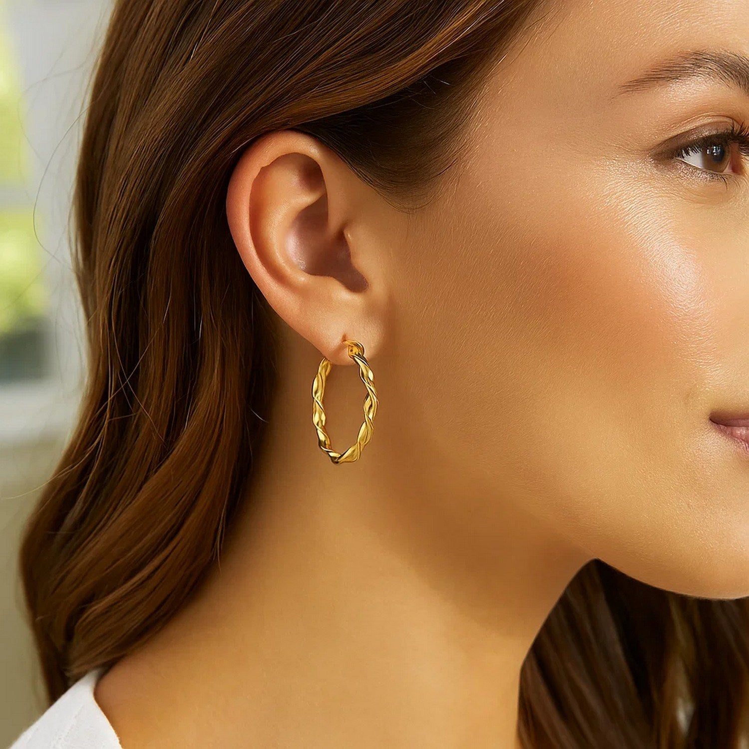 14k yellow gold modern hoop earrings, 25mm, showcasing a sleek design perfect for elegant occasions.