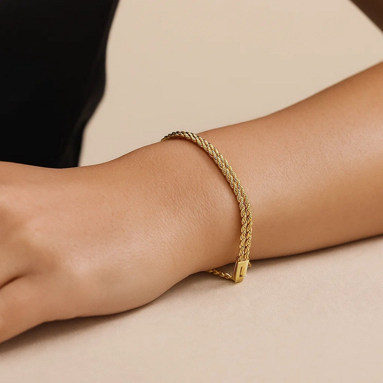 14k yellow gold two-row rope bracelet featuring a modern design with elegant chain details.