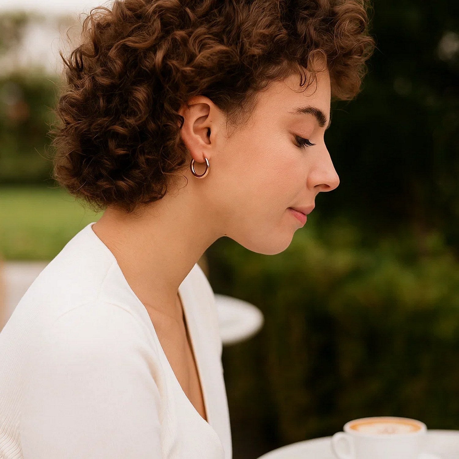 14k rose gold polished hoop earrings with a sleek minimalist design, perfect for elegant everyday wear.