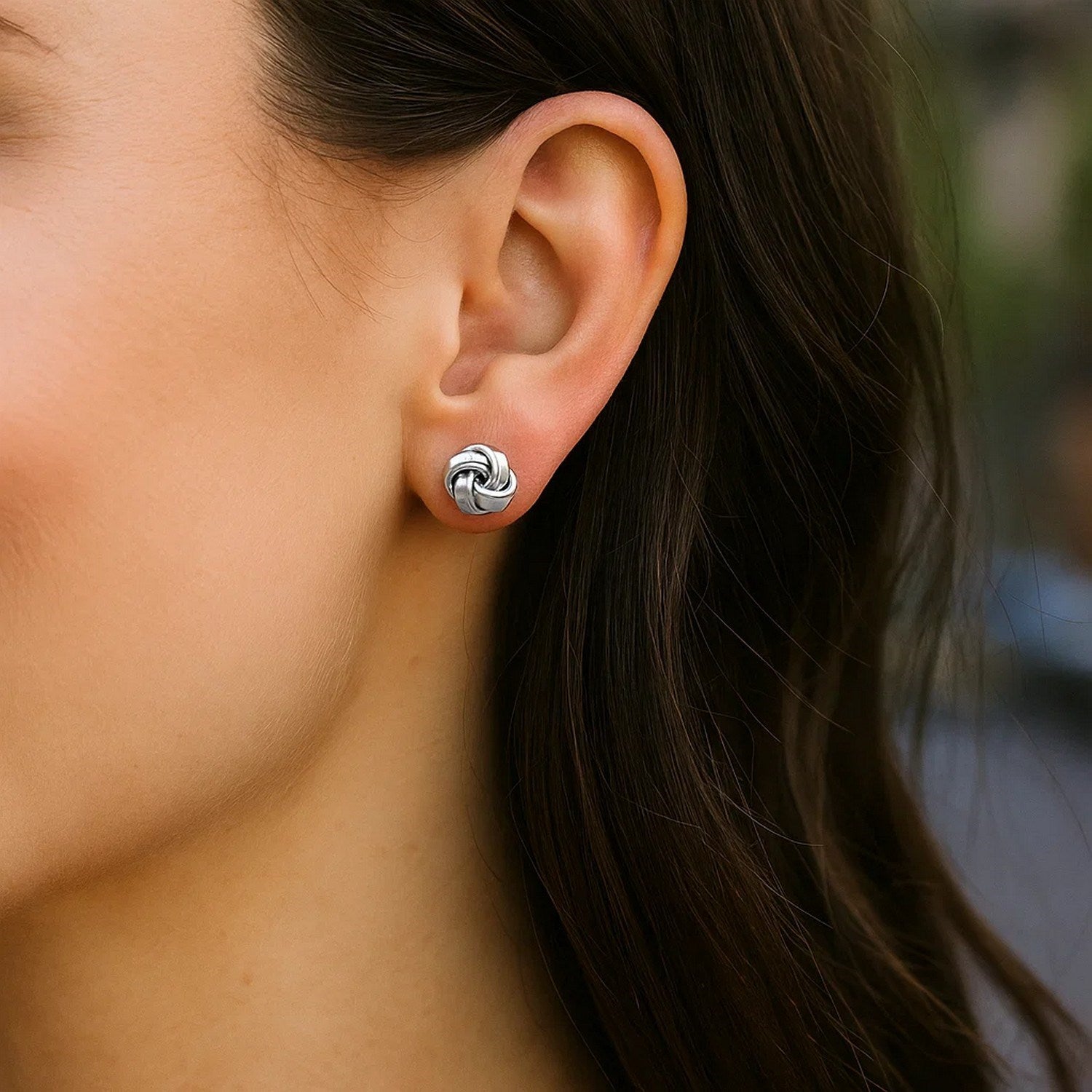 Sterling silver polished petite love knot earrings showcasing a timeless design for elegant sophistication.