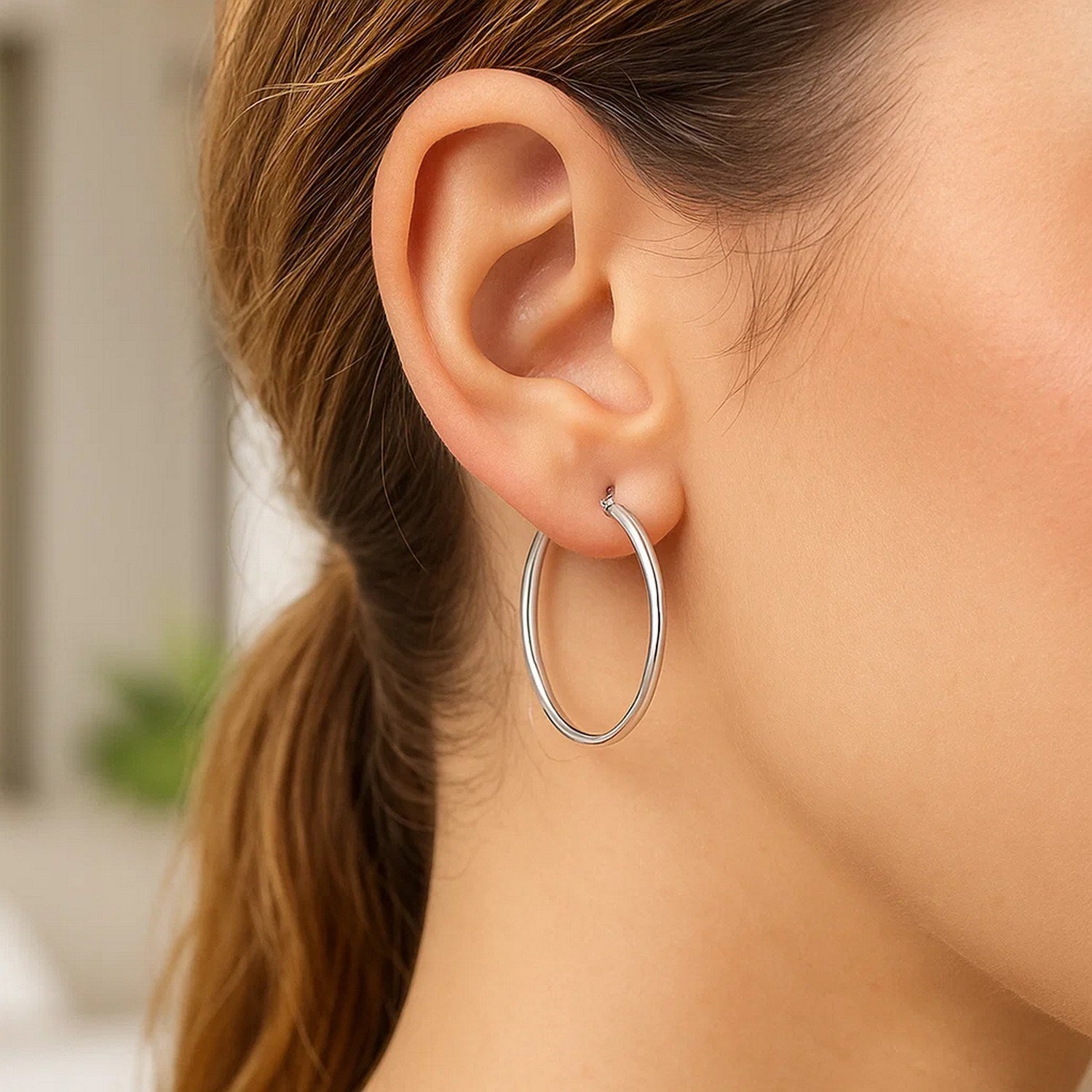 Sterling silver polished hoop earrings with rhodium plating, modern design, elegant 30mm size.