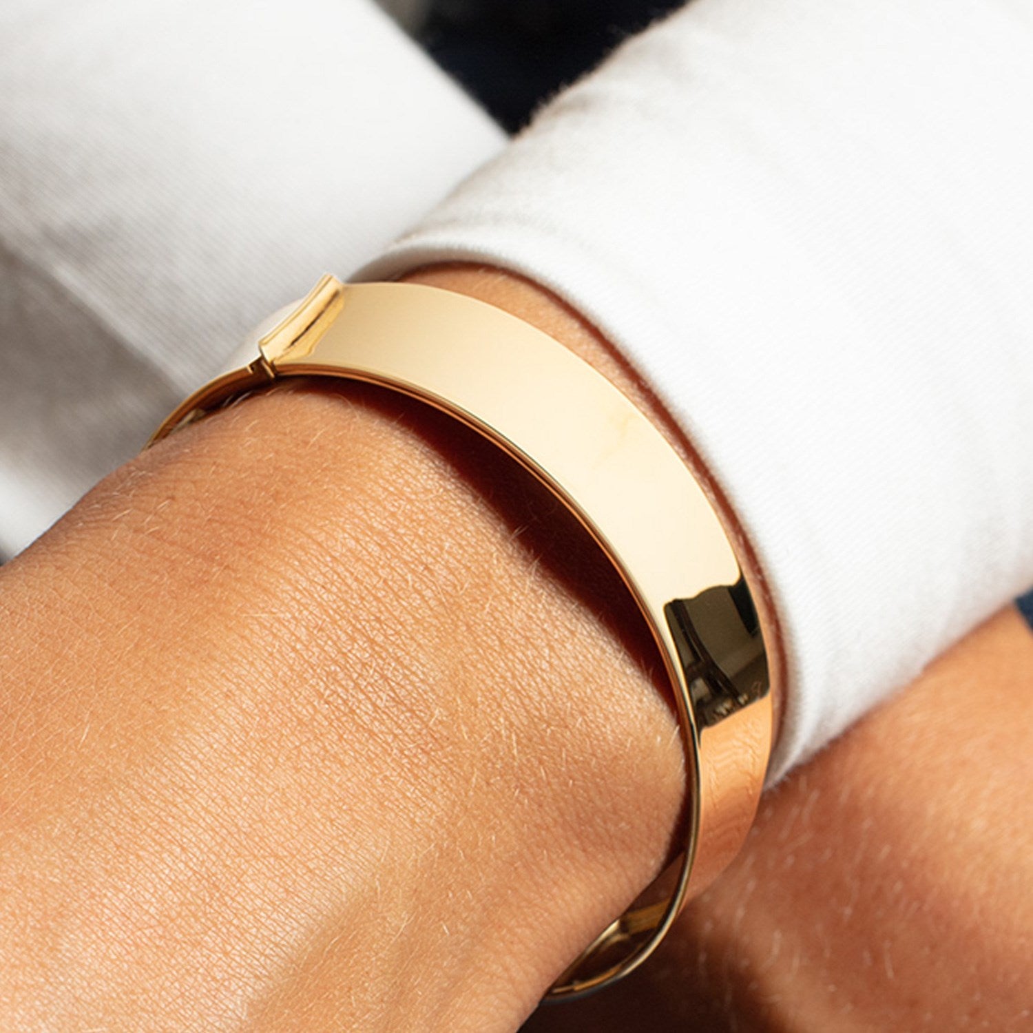 Designer medium width bracelet in 14k yellow gold, showcasing a modern luxury style with a sleek 14.50 mm design.