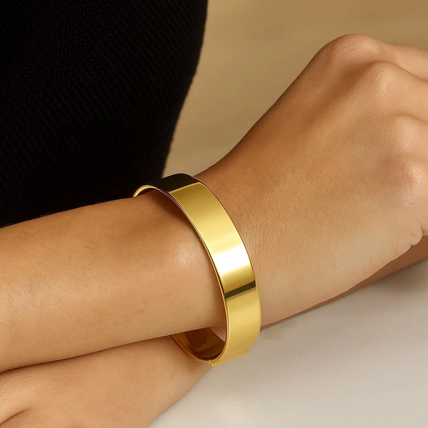 Designer medium width bracelet in 14k yellow gold, showcasing modern elegance and luxurious craftsmanship.