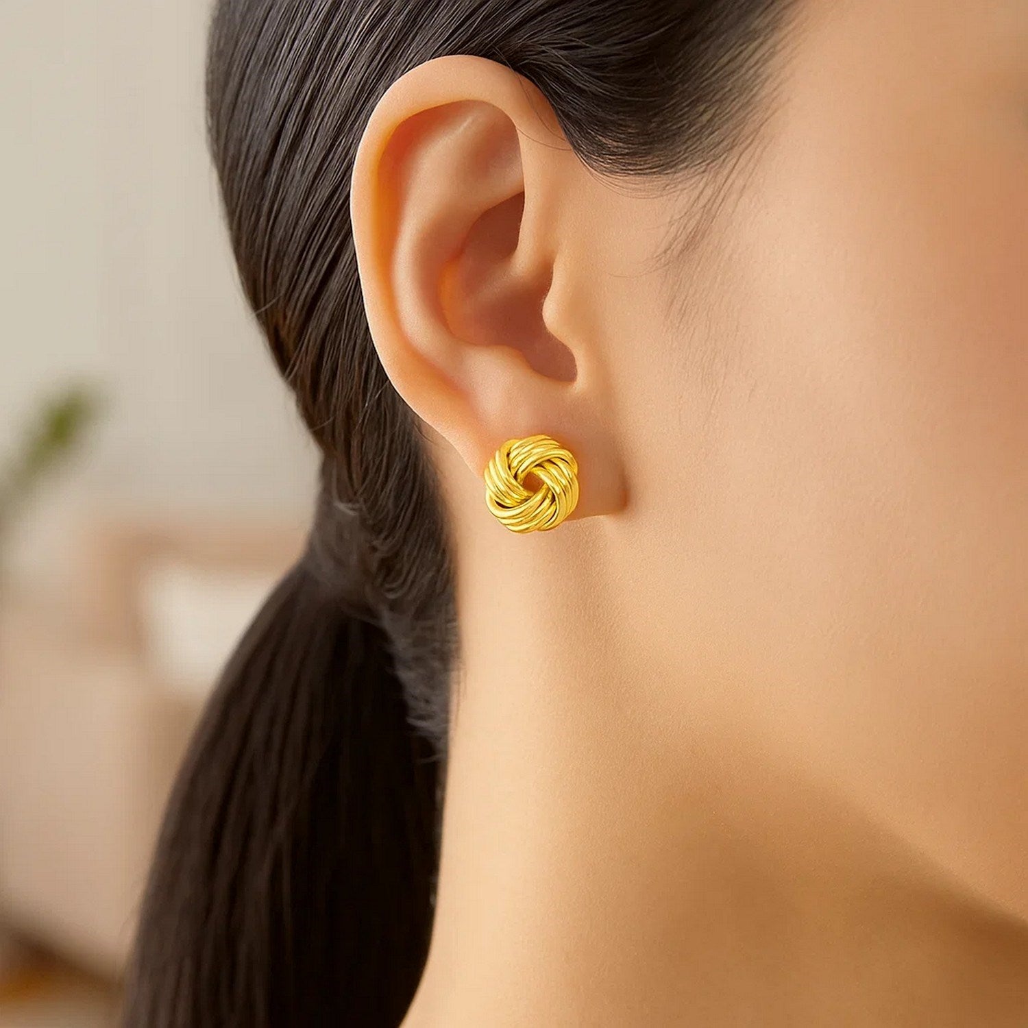 14k yellow gold love knot post earrings featuring a modern design, perfect for elegant everyday wear.