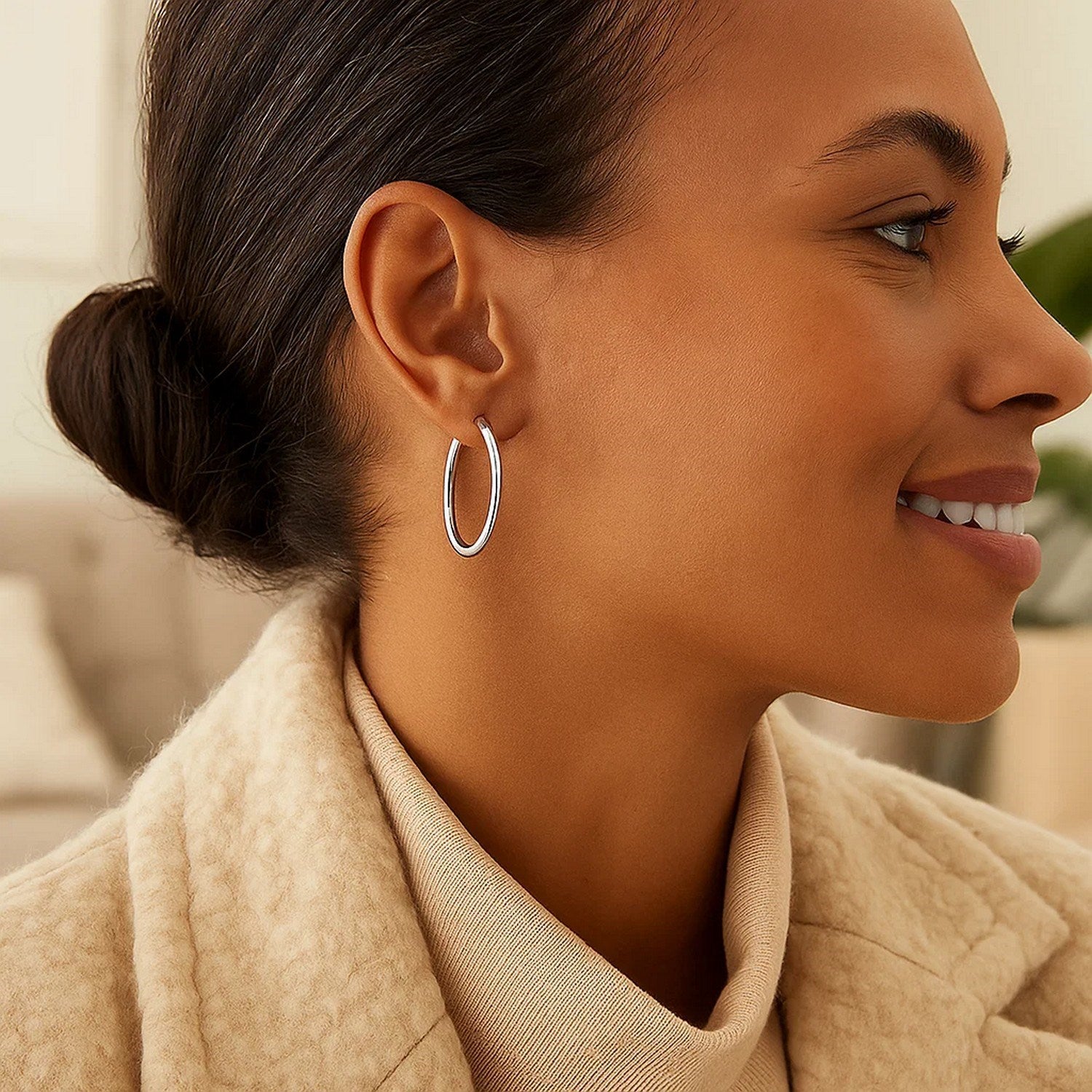 Sterling silver polished hoop earrings with a modern design, showcasing a sleek and elegant finish.