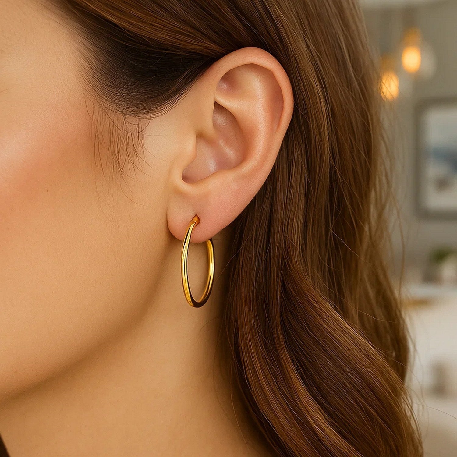 14k yellow gold polished hoop earrings with a modern design, showcasing elegance and timeless sophistication.