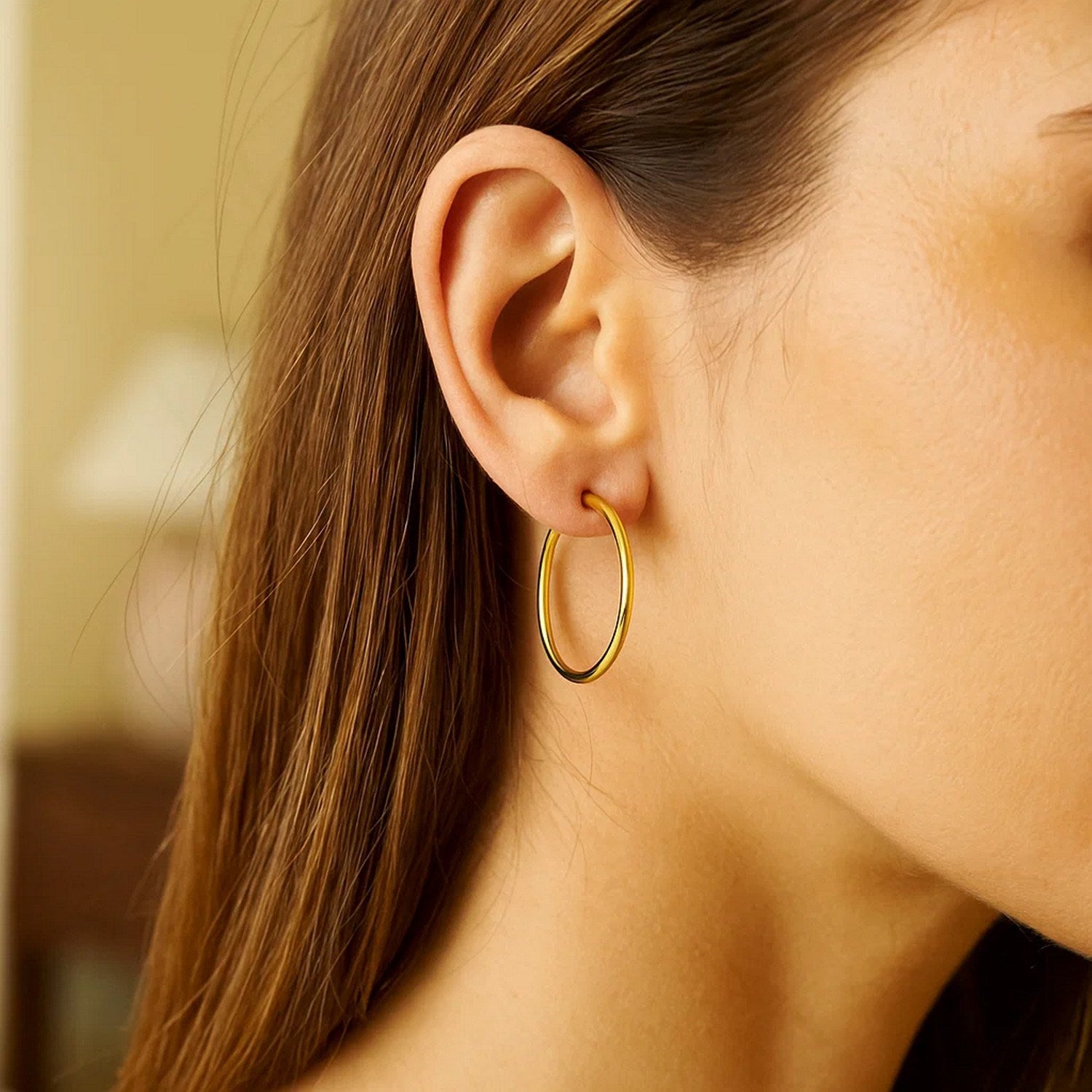 14k yellow gold polished hoop earrings with a modern design, perfect for elegant everyday wear.