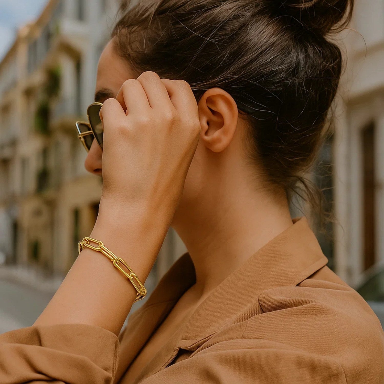 Long domed paperclip bracelet in 14k yellow gold, showcasing a modern design with elegant link detailing.
