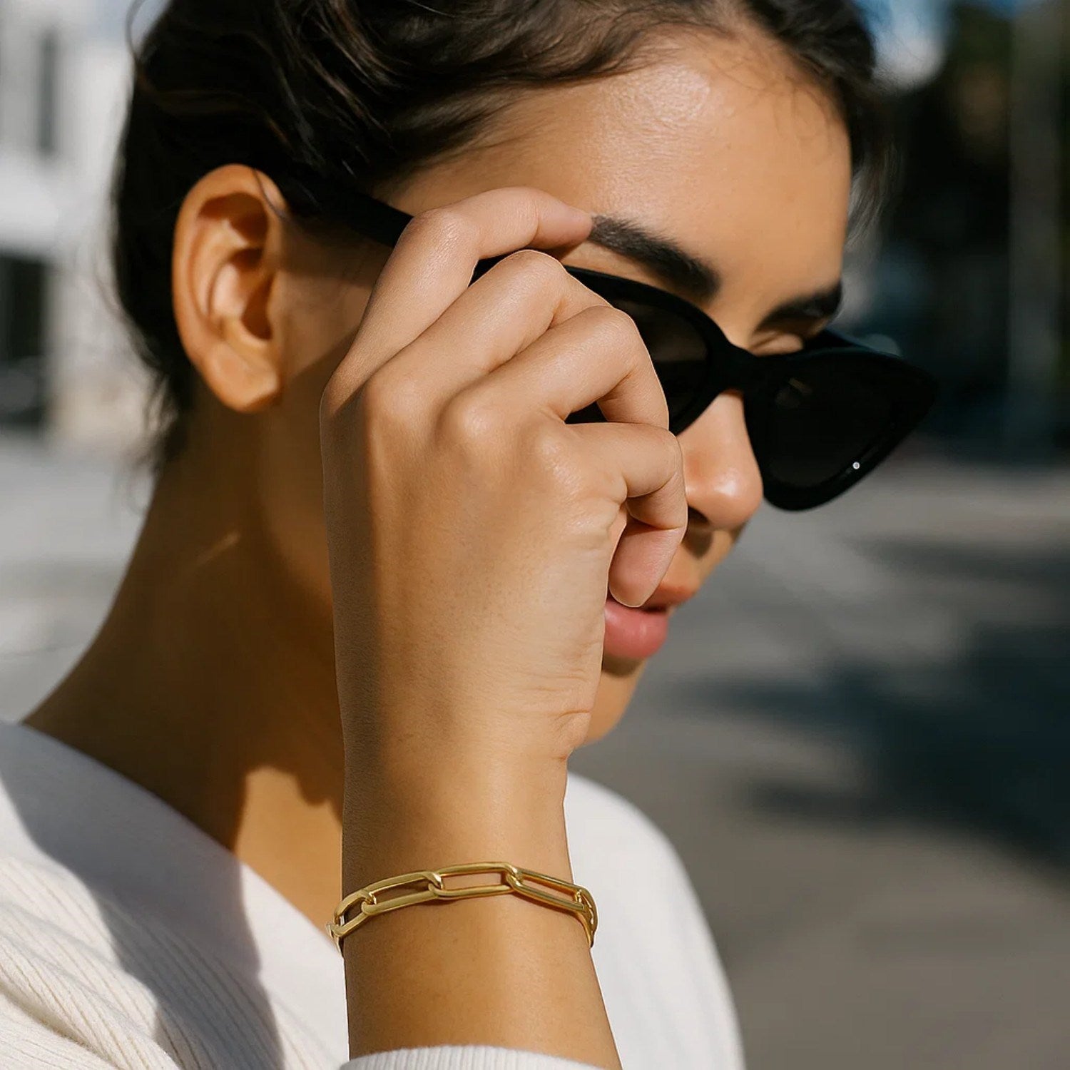 Long domed paperclip bracelet in 14k yellow gold, featuring modern link design and elegant shine.