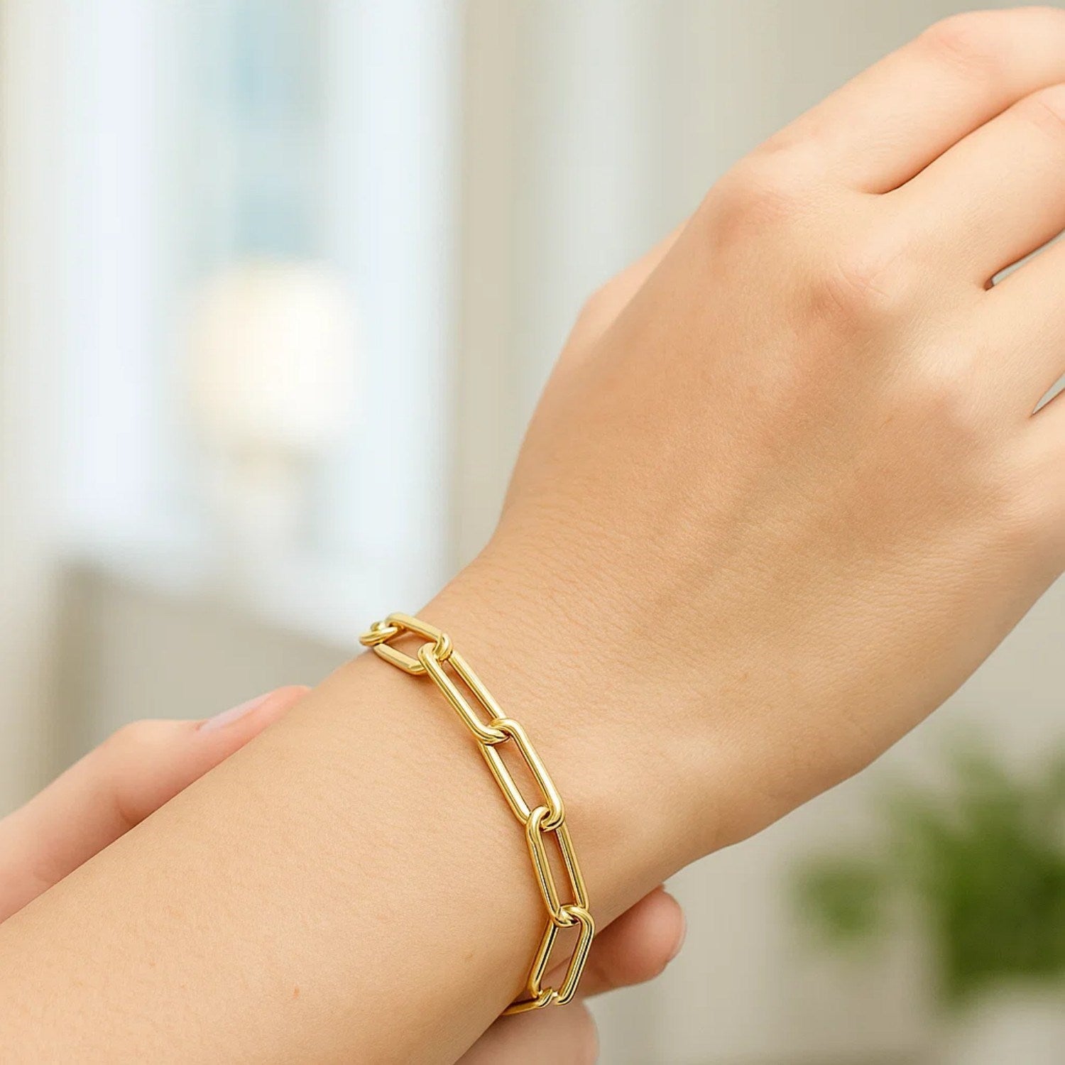 Long domed paperclip bracelet in 14k yellow gold, showcasing modern elegance and refined link design.