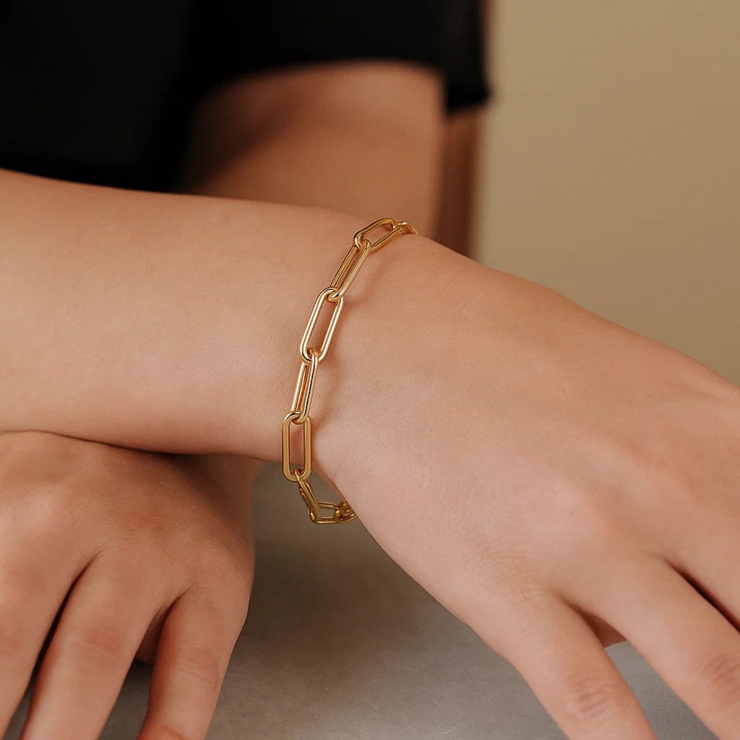 Long domed paperclip bracelet in 14k yellow gold, showcasing a modern link design with elegant simplicity.
