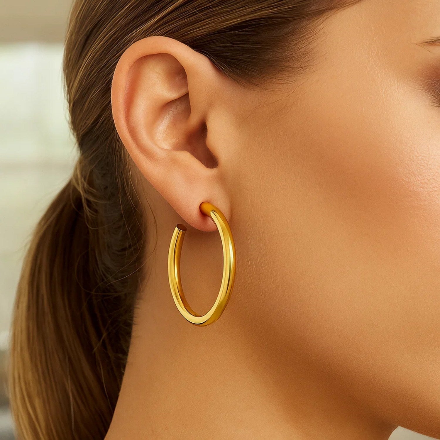 14k yellow gold polished hoop earrings with a sleek modern design, perfect for elegant everyday wear.