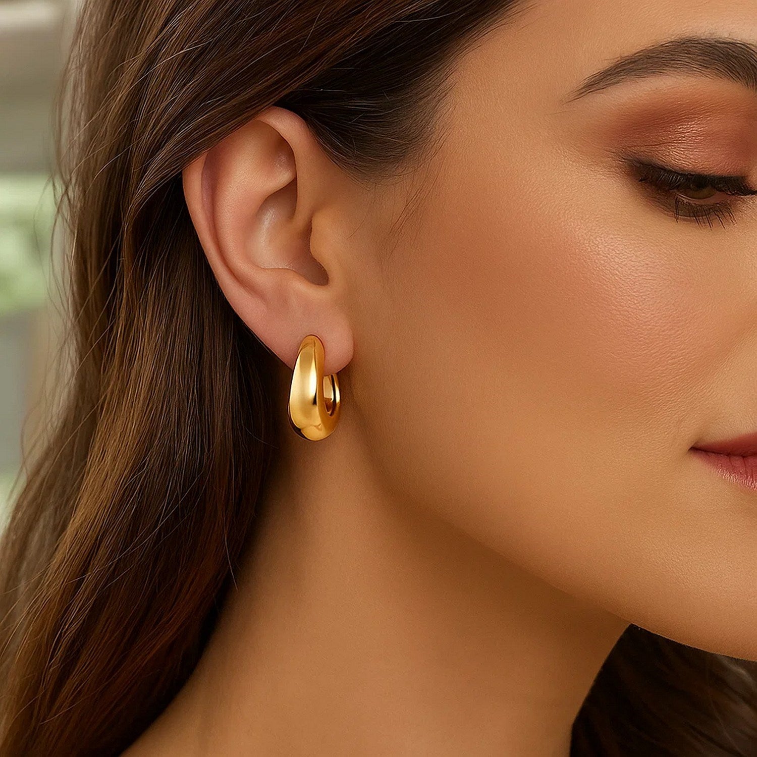 14k yellow gold tapered hoop earrings showcasing a modern design with a polished finish for elegant sophistication.