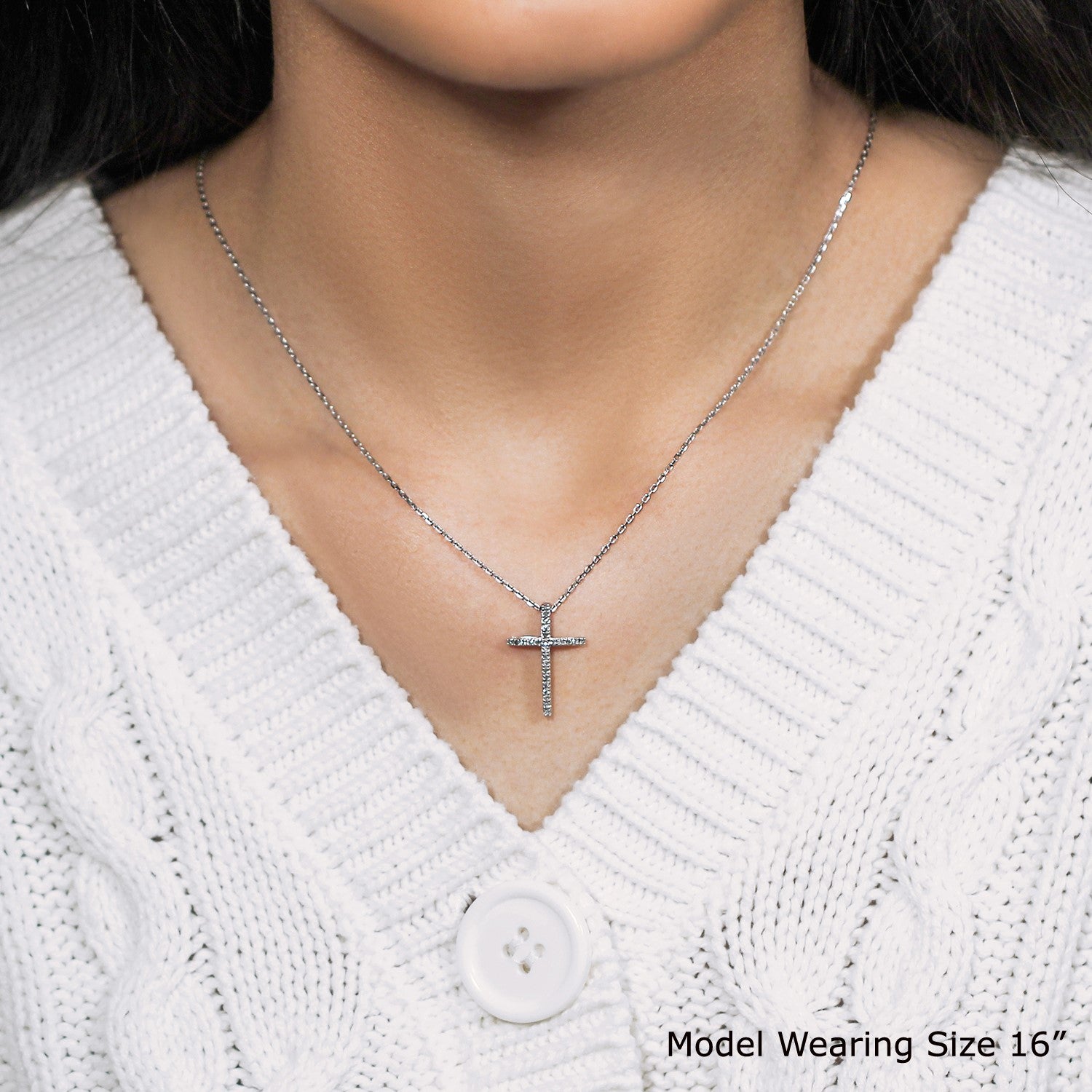 Narrow sterling silver cross pendant adorned with sparkling diamonds, featuring a sleek modern design and elegant chain.