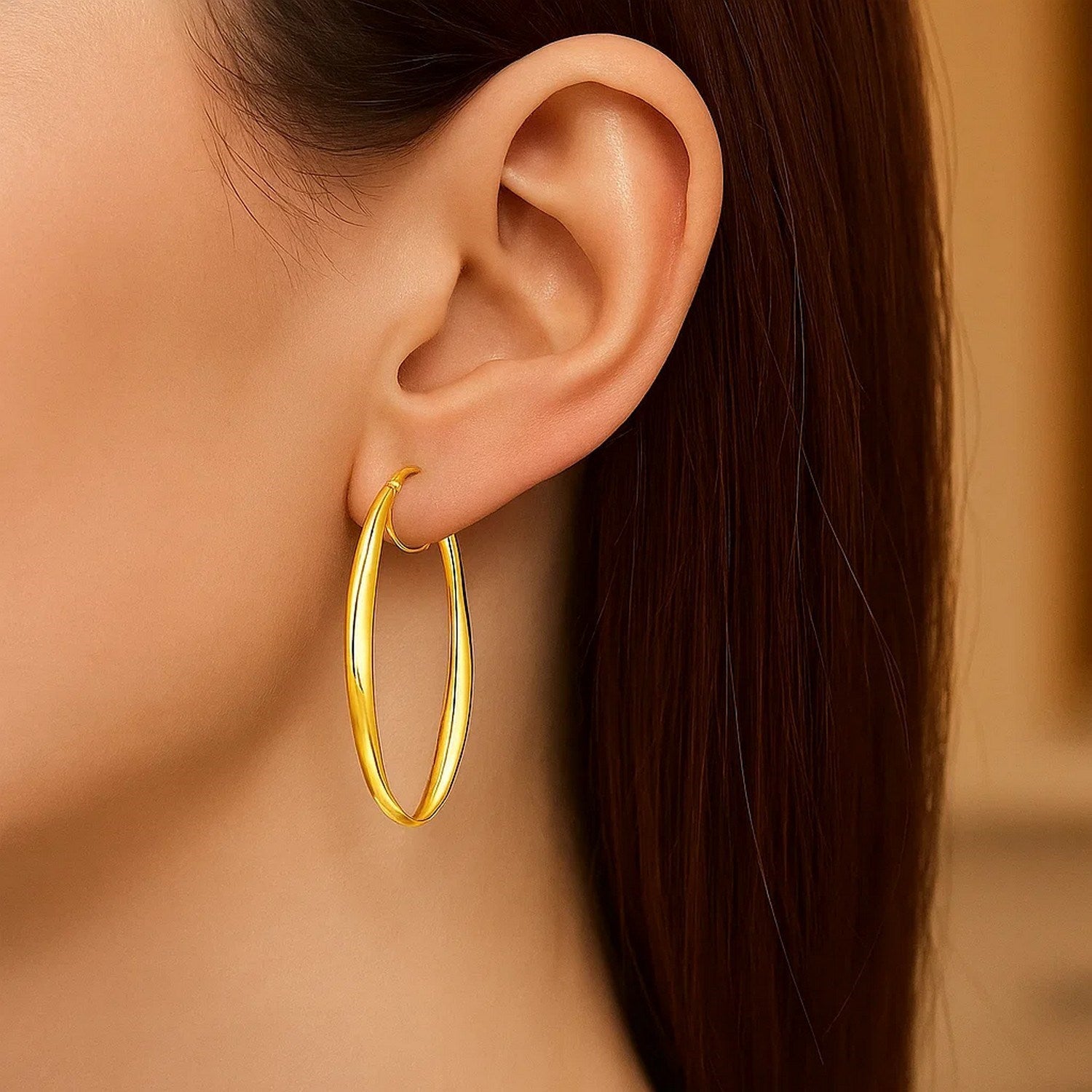 14k yellow gold twist motif hoop earrings with a modern oval design, perfect for elegant occasions.