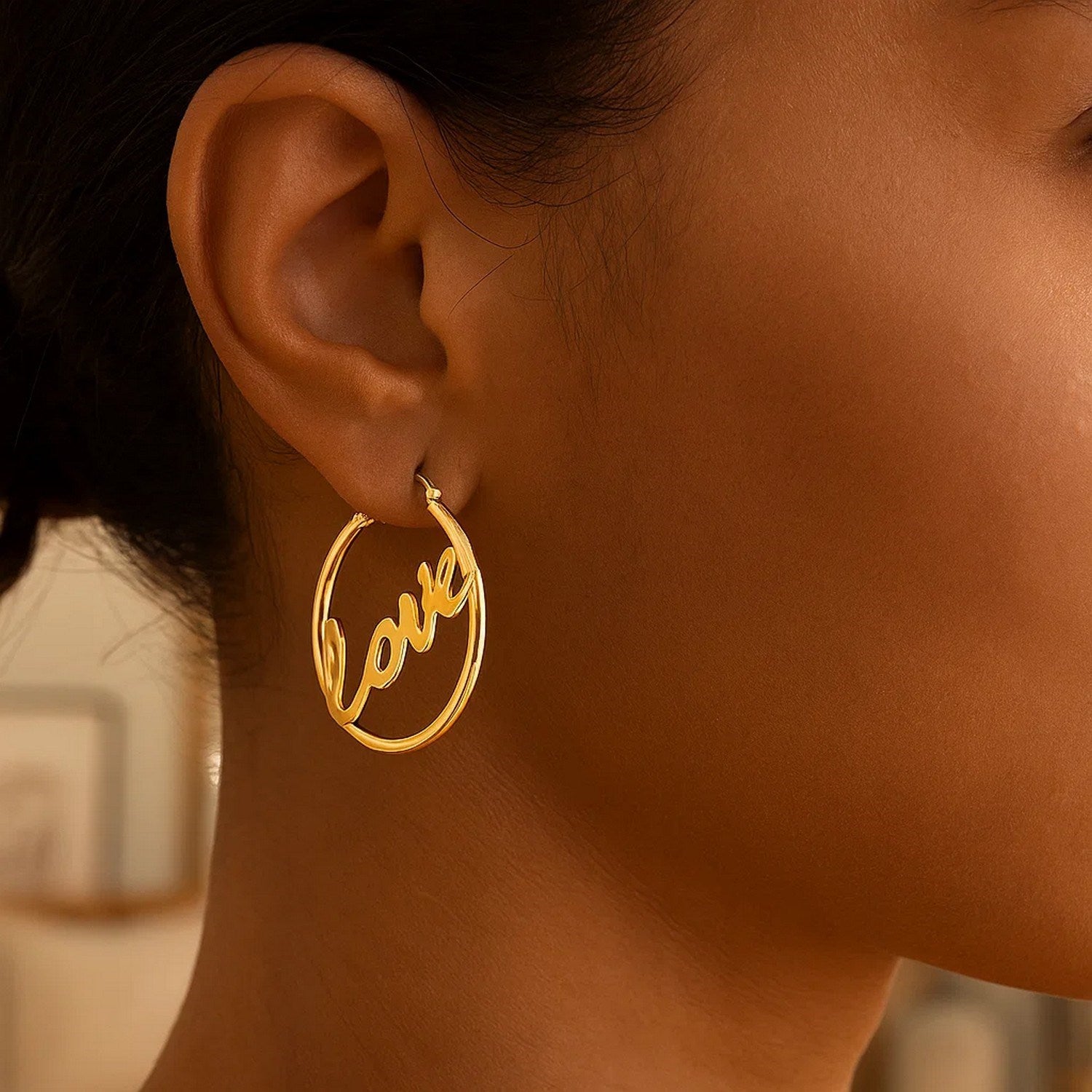 14K yellow gold modern hoop earrings featuring a sleek design and luxurious finish, perfect for elegant occasions.