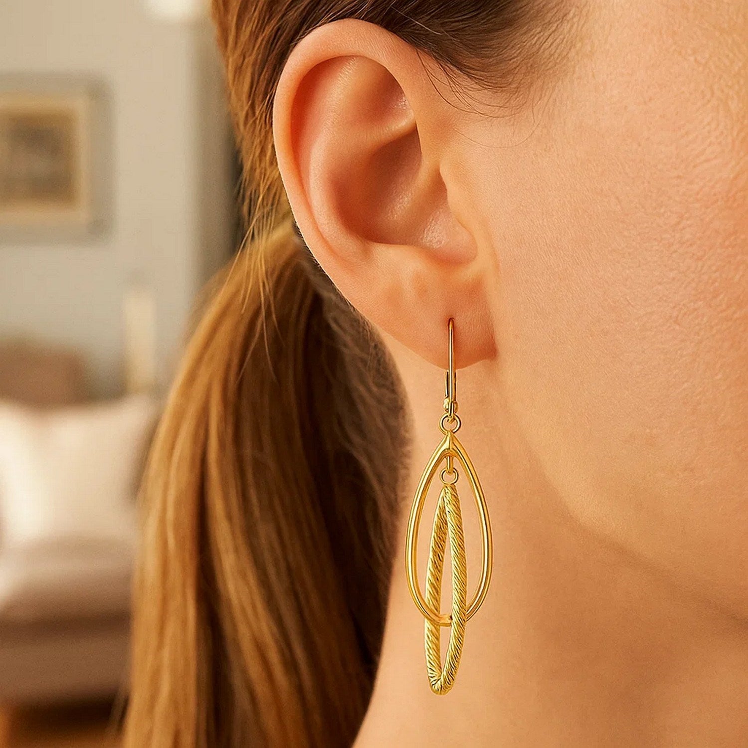 14k yellow gold textured dangle earrings with modern design and elegant stud feature for a luxurious look.