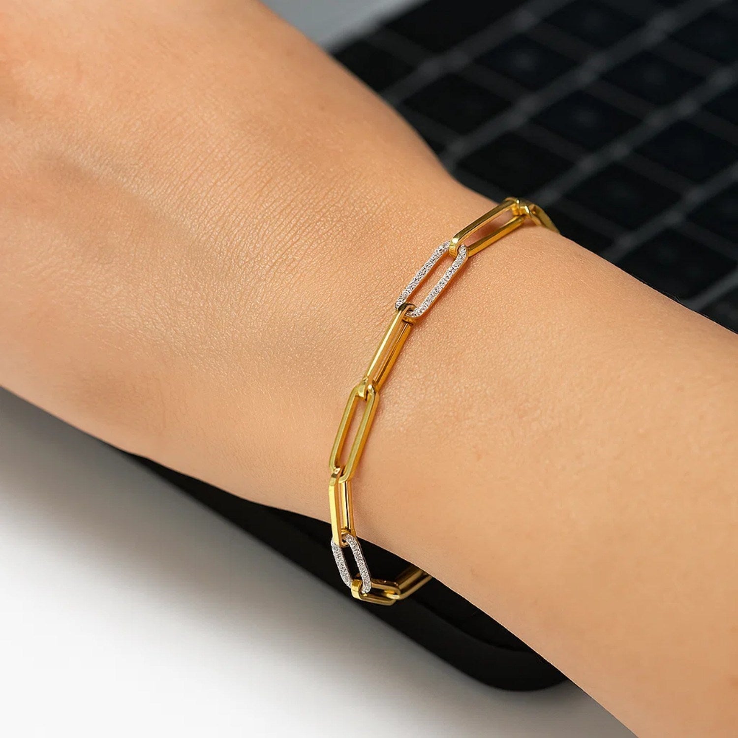 14k yellow gold paperclip chain bracelet featuring three exquisite diamond links for a modern, elegant touch.